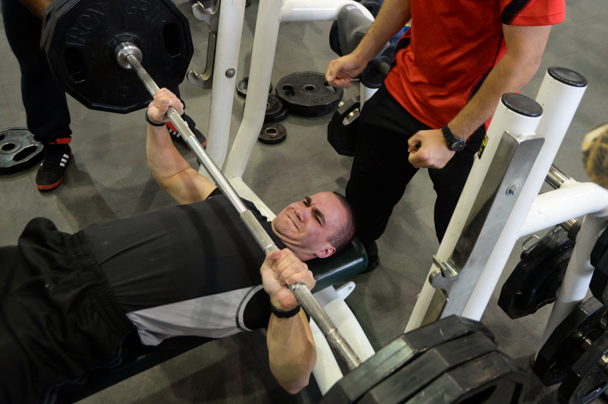 U.S. Air Force Senior Airman Bryan Hernandez, 88th Security Forces Squadron patrolman, participates in the bench press event as part of the Powerlifting Competition held at Wright Field Fitness Center, Wright-Patterson Air Force Base, Ohio, November 15, 2014. Eight power lifters competed in the competition. (U.S. Air Force photo by Wesley Farnsworth / Released)