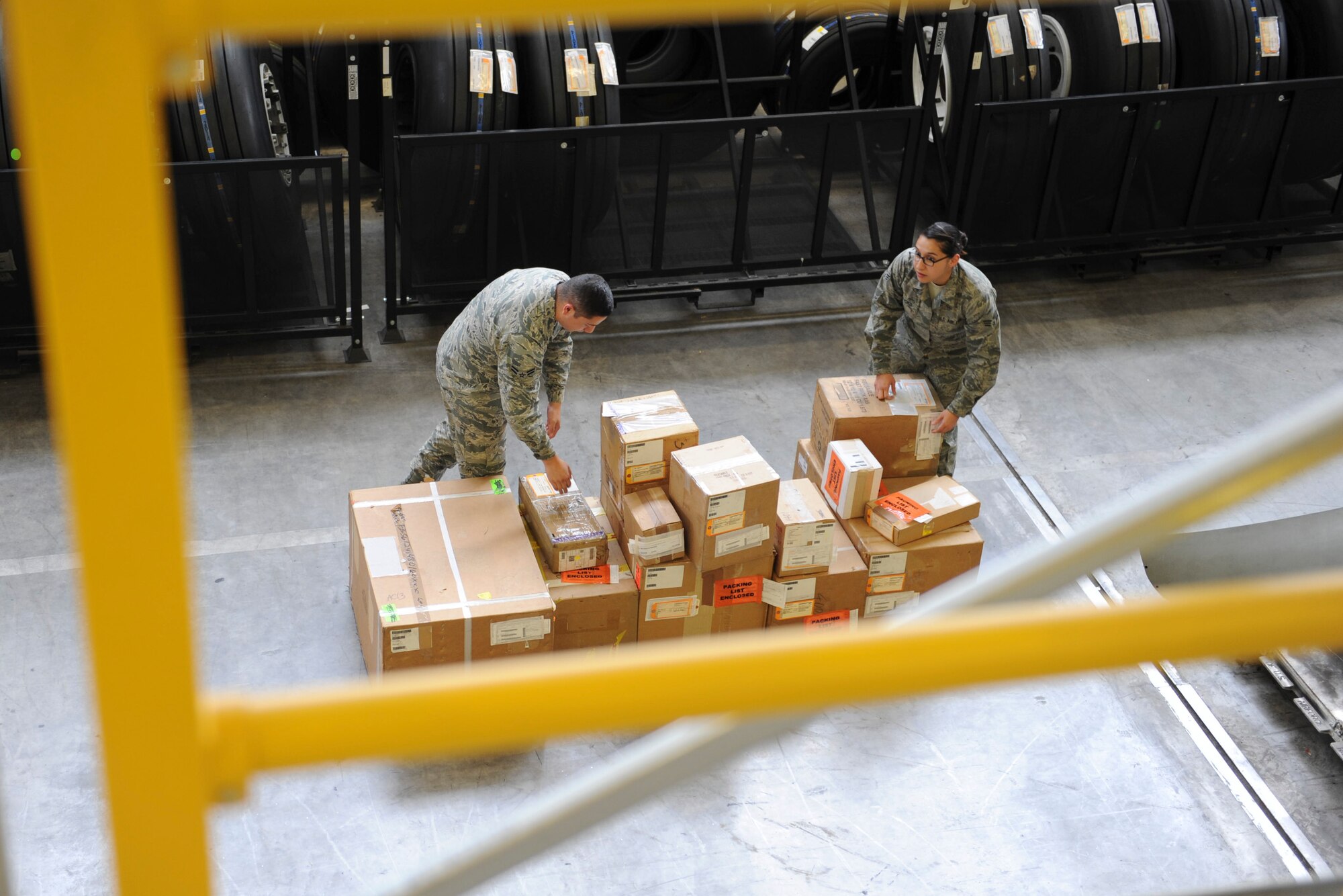 Supply journeymen from the 86th Logistics Readiness Squadron sort out equipment and prepare for a contingency tasking on Ramstein Air Base, Germany, Sep. 24, 2014. To get ready for a contingency tasking, the 86th LRS pulls aircraft parts from a warehouse, stage it, conduct inventory and then get it ready for missions. (U.S. Air Force photo/Airman 1st Class Michael Stuart) 