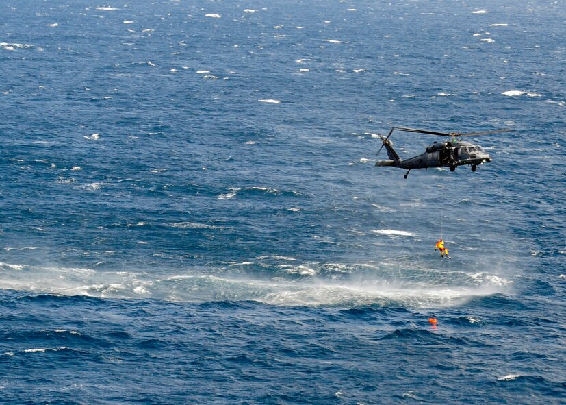 A U.S. Air Force pararescueman with the 212th Rescue Squadron repels from one of the 33rd Rescue Squadron's HH-60G Pave Hawk helicopters to save a simulated drowning victim in a scenario that was part of Exercise Keen Sword 2015 near Komatsu Air Base, Japan, Nov. 12, 2014. The scenario was designed for joint-bilateral training with Japan Self Defense Force rescue crews. The training allows aircrews and pararescuemen to practice what they would do in a real world situation. The 212th RQS is assigned to Joint Base Elmendorf-Richardson, Alaska, and the 33rd RQS is assigned to Kadena Air Base, Japan. (U.S. Air Force photo by 2nd Lt. Erik Anthony/Released) 