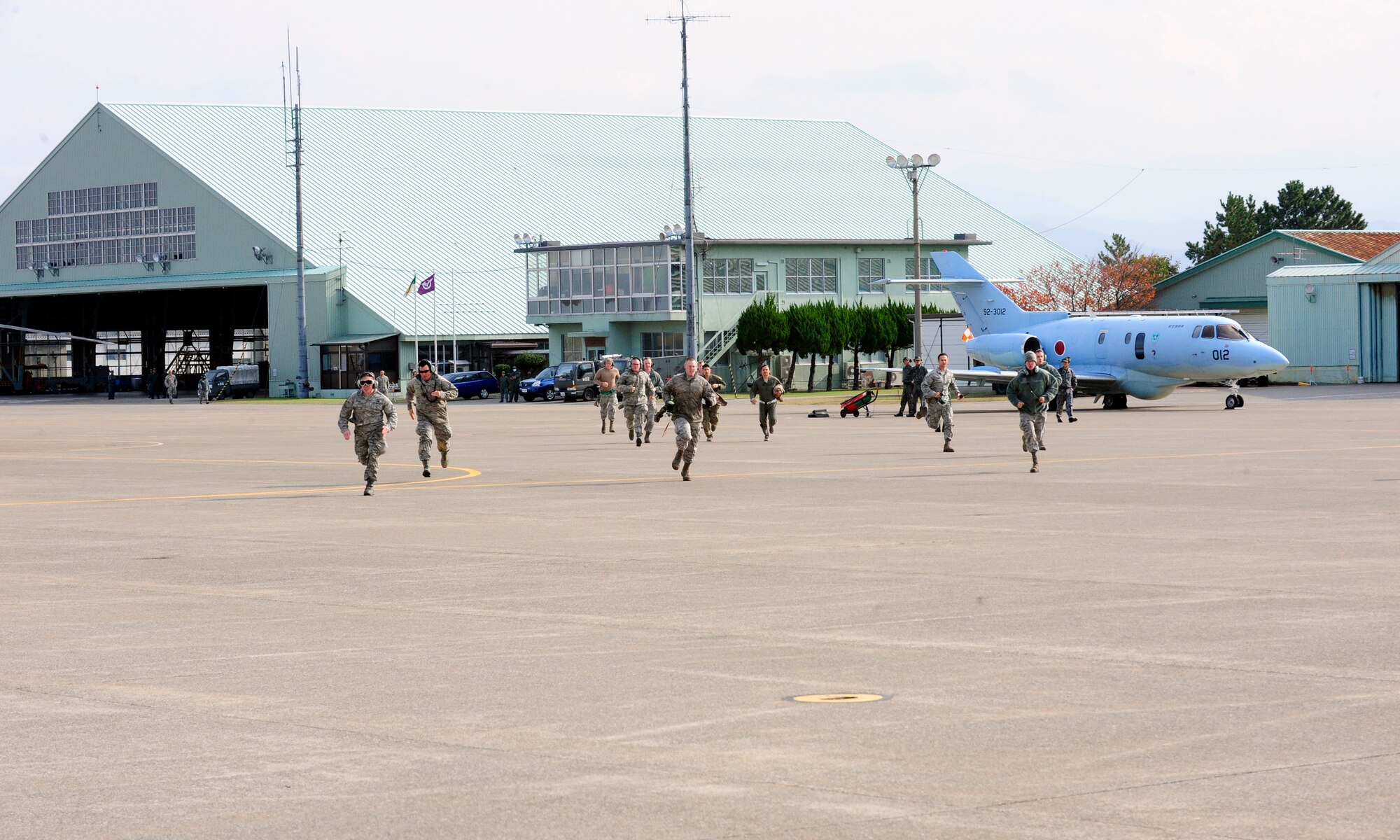 U.S. Air Force personnel sprint to U.S. Air Force HH-60G Pave Hawk helicopters in response to an exercise scenario on Komatsu Air Base, Japan, Nov. 12, 2014. The scenario was part of exercise Keen Sword 2015, a joint-bilateral training exercise designed to increase the interoperability required to support the defense of Japan, respond to a potential crisis and offer humanitarian assistance. The Pave Hawks are assigned to the 33rd Rescue Squadron stationed at Kadena Air Base, Japan. (U.S. Air Force photo by 2nd Lt. Erik Anthony/Released)