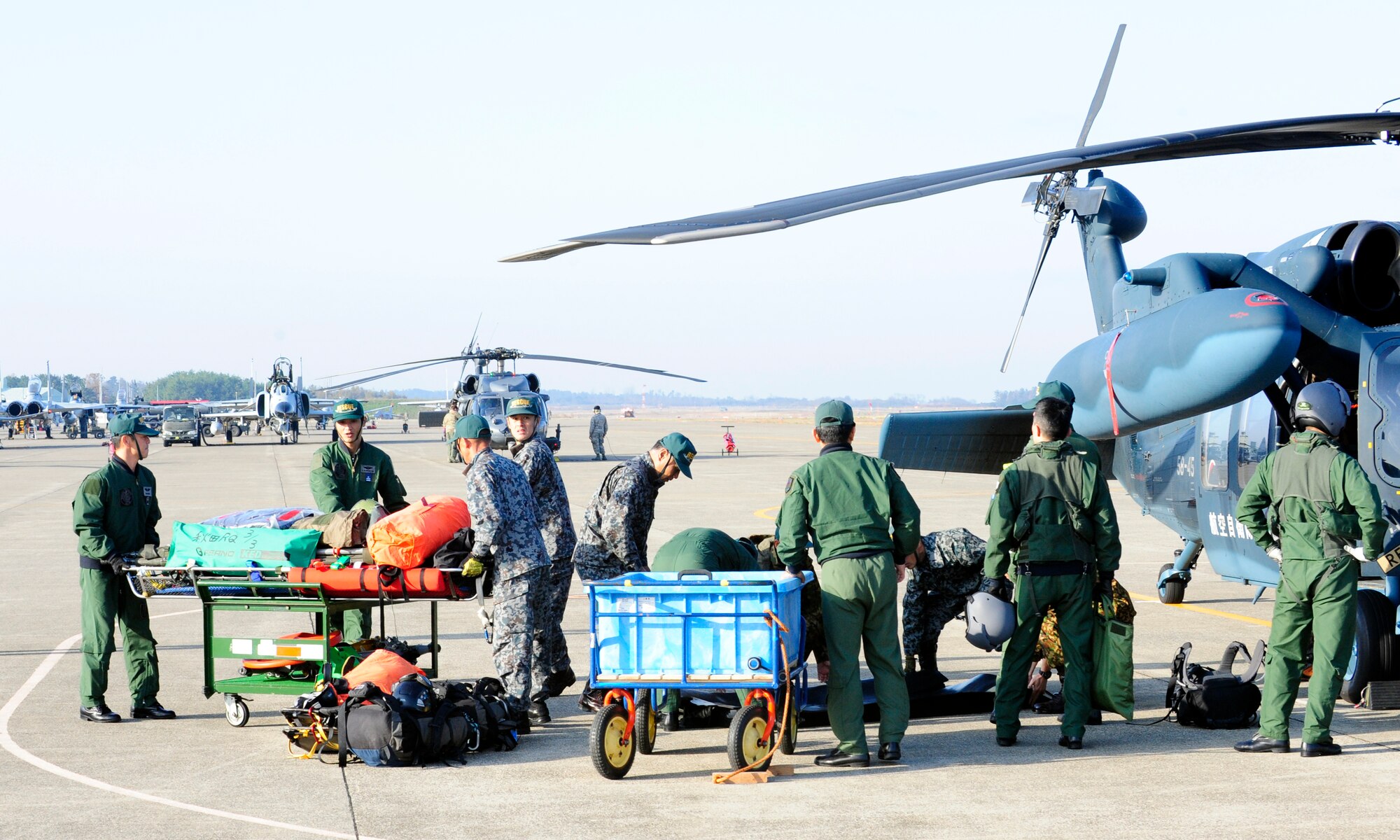 Komatsu Air Rescue Squadron personnel load a Japan Air Self-Defense Force HH-60J helicopter in response to an exercise scenario on Komatsu Air Base, Japan, Nov. 12, 2014. The scenario was part of exercise Keen Sword 2015, a joint-bilateral training exercise designed to increase the interoperability required to support the defense of Japan, respond to a potential crisis and offer humanitarian assistance. (U.S. Air Force photo by 2nd Lt. Erik Anthony/Released)