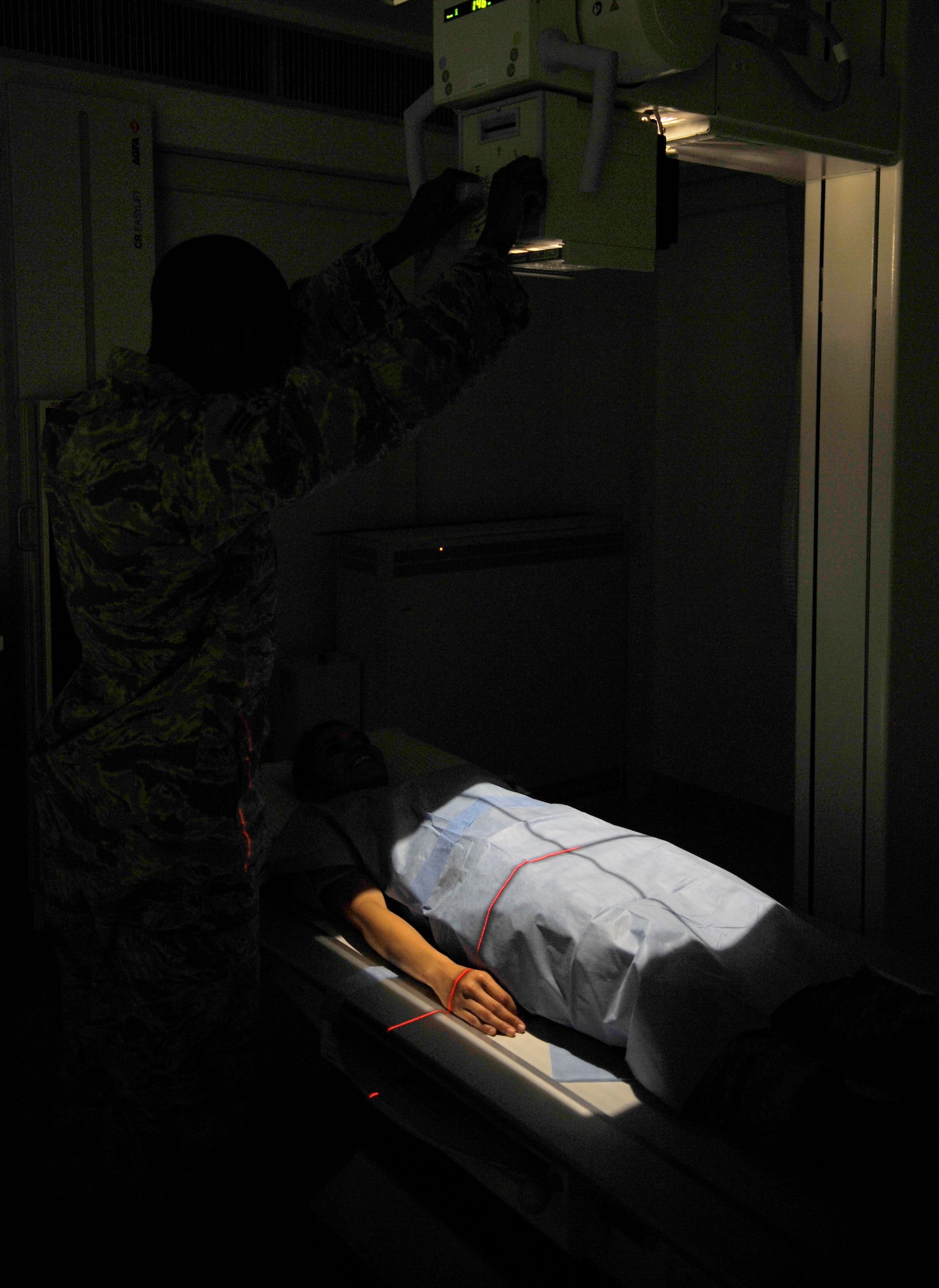 Senior Airman Travis Pettis, 86th Medical Support Squadron radiology technologist, positions an x-ray tube over a simulated patient Sept. 24, 2014 at Ramstein Air Base, Germany. The 86th MDSS works closely with the Landstuhl Regional Medical Center radiologists to help find patients’ diagnoses. (U.S. Air Force photo/Airman Larissa Greatwood)