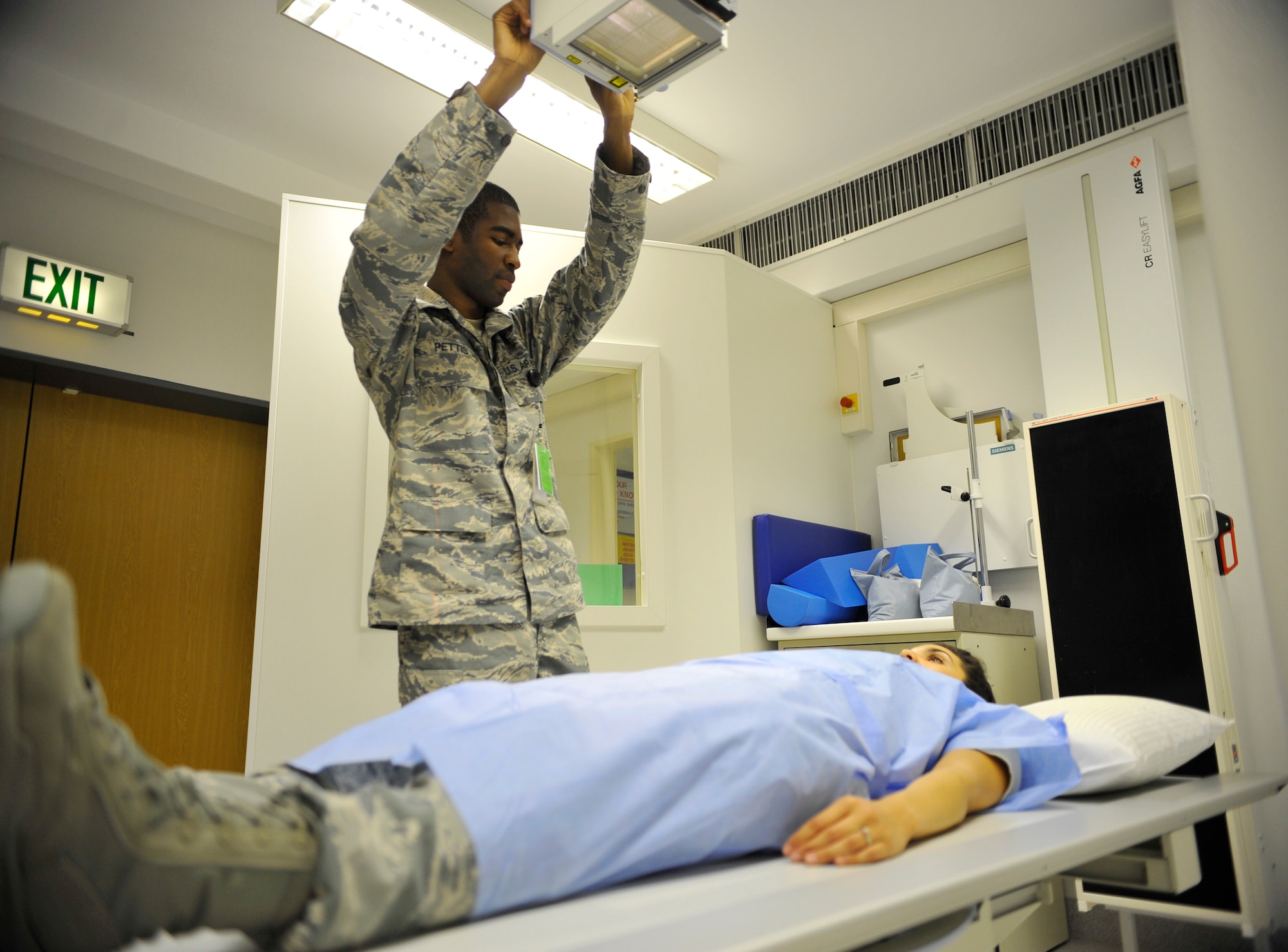 Senior Airman Travis Pettis, 86th Medical Support Squadron radiology technologist, positions an x-ray tube over a simulated patient Sept. 24, 2014 at Ramstein Air Base, Germany. The 86th MDSS takes x-rays to detect broken bones, fractures and even illnesses such as pneumonia. (U.S. Air Force photo/Airman Larissa Greatwood)