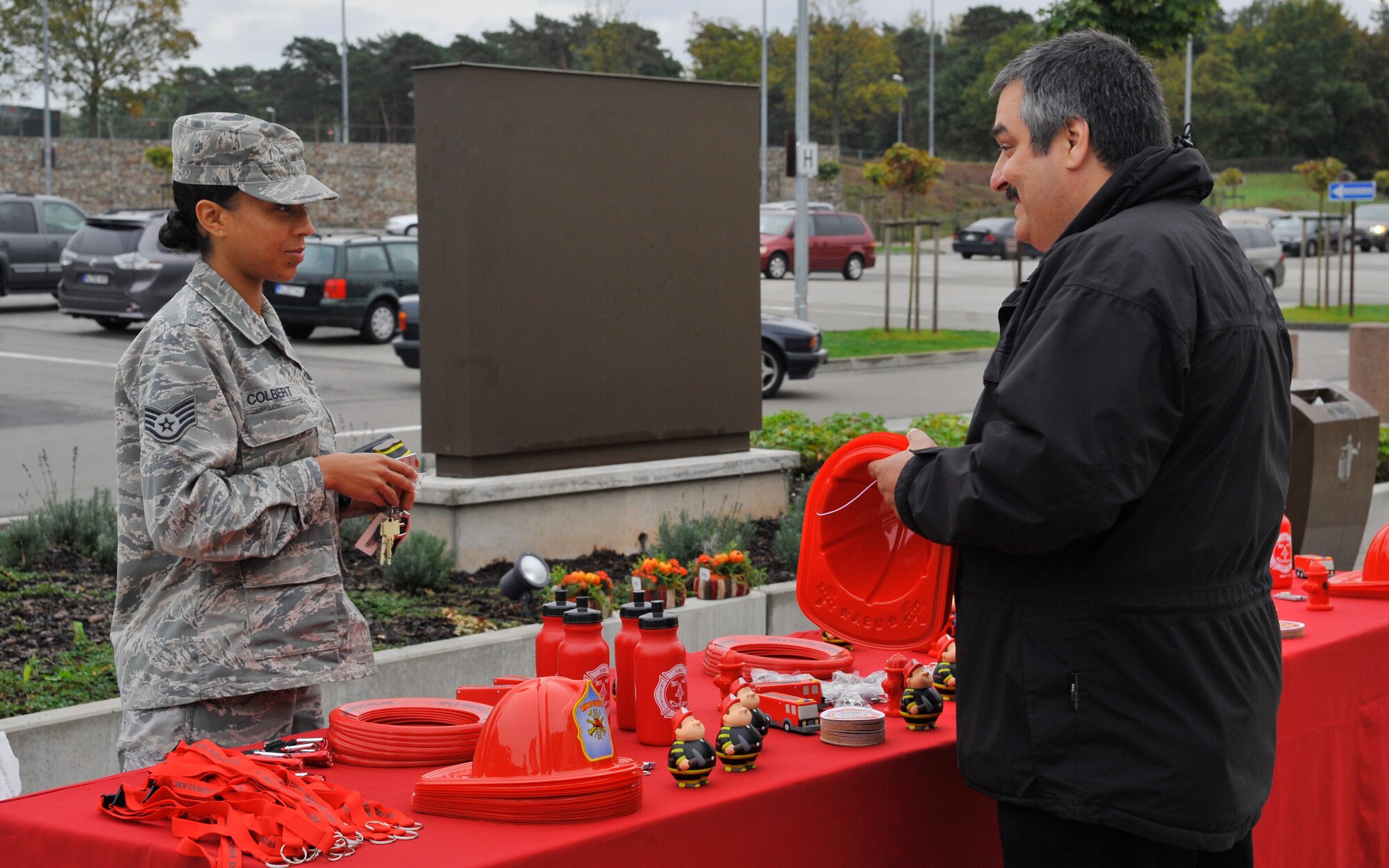 Felipe Vazquez, 86th Civil Engineer Squadron Fire Department assistant chief for fire prevention, talks to a member of Team Ramstein about the importance of checking smoke detectors on Oct. 9, 2014 at Ramstein Air Base, Germany. The theme for this year’s Fire Prevention Week was testing smoke detectors twice a year. (U.S. Air Force photo/Airman Larissa Greatwood)