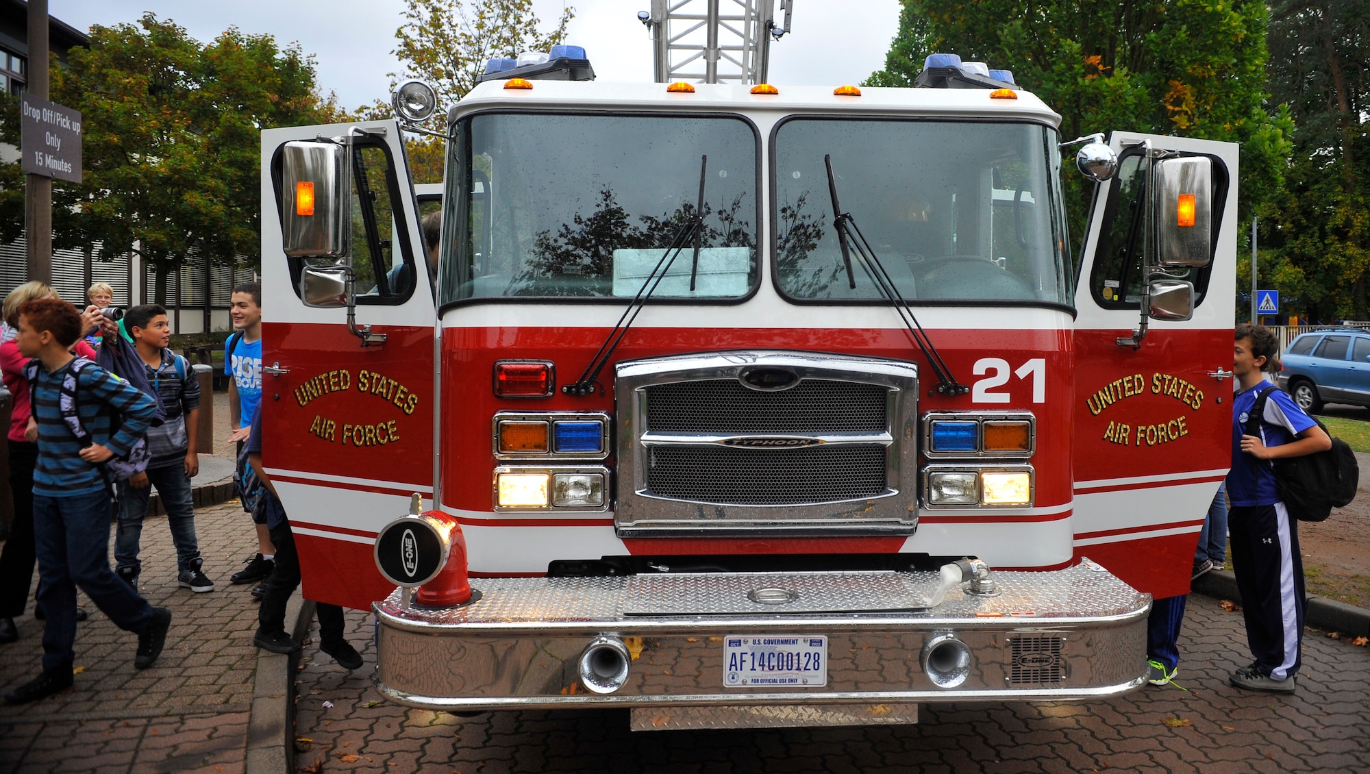 Ramstein Middle School students climb into the front seats of a fire truck during Fire Prevention Week on Oct. 9, 2014 at Ramstein Air Base, Germany. The students learned about the importance of fire safety and how the 86th CES firefighters respond to emergency situations. (U.S. Air Force photo/Airman Larissa Greatwood)