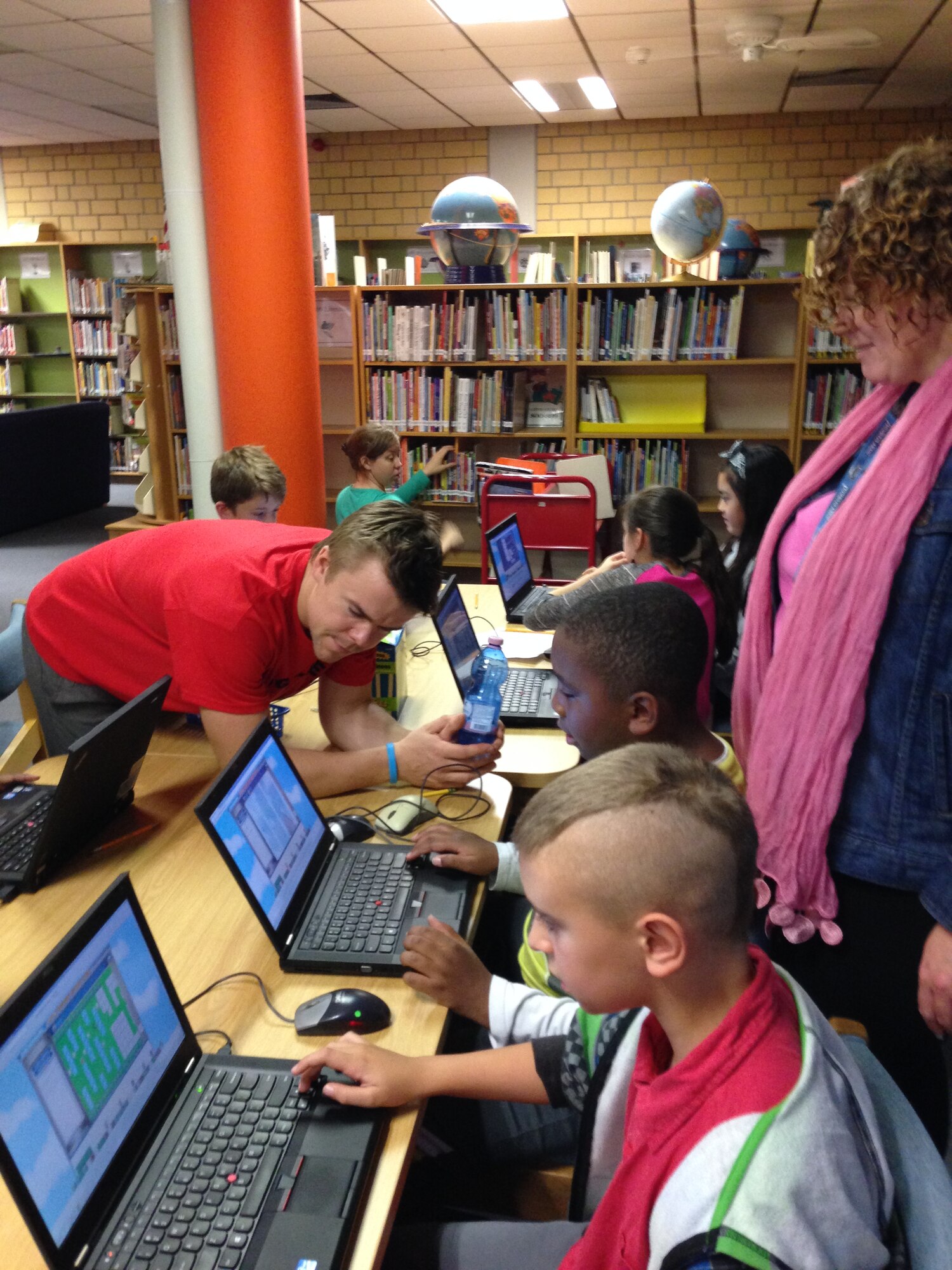 Santeri Koivisto, MinecraftEdu chief executive officer and co-founder, and Laurie Arensdorf, Vogelweh Elementary School fifth grade teacher, watch as students work on program coding in MinecraftEdu at Vogelweh Elementary School. Students from Kaiserslautern Middle, Vogelweh Elementary and Landstuhl Elementary schools had the opportunity to learn computer coding through MinecraftEdu from Oct. 16 to 17. (Courtesy photo)