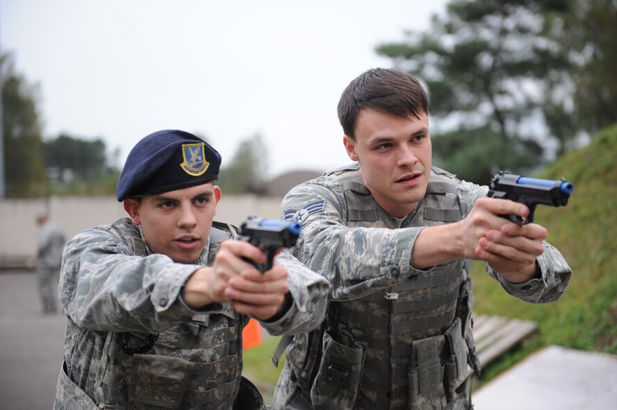 Airman 1st Class Wesley Baker and Senior Airman Calvin Howard, 86th Security Forces Squadron members complete a tactical movement drill during “Shoot, Move, Communicate” training on Ramstein Air Base, Germany, Oct. 10, 2014. The four-hour training was an opportunity for defenders to refresh some of their combat skills. (U.S. Air Force photo/Airman 1st Class Michael Stuart)