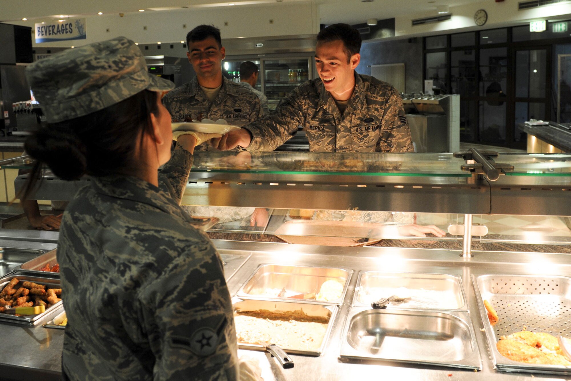 Airman Tiffani Ortiz, 786th Force Support Squadron food server apprentice, serves customers in the Rhineland Inn Dining Facility on Ramstein Air Base, Germany, Oct. 8, 2014. The Rhineland Inn Dining Facility provides Airmen with a “grab-n-go” service which allows Airmen to take their food to go. (U.S. Air Force photo/Airman 1st Class Michael Stuart)
