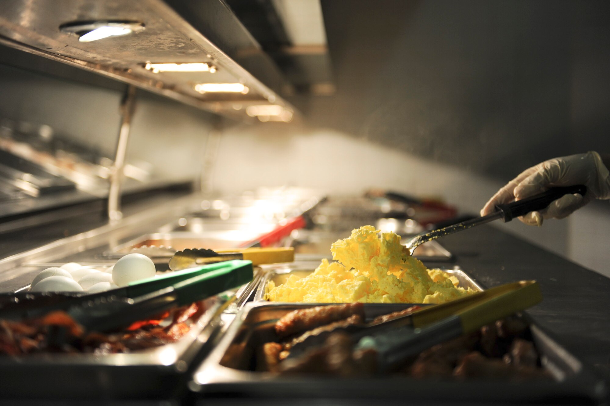 Airman Tiffani Ortiz, 786th Force Support Squadron food server apprentice, serves customers in the Rhineland Inn Dining Facility on Ramstein Air Base, Germany, Oct. 8, 2014. The Rhineland Inn Dining Facility is open four times a day to provide Airmen who work obscure hours a chance to eat a home-cooked meal. (U.S. Air Force photo/Airman 1st Class Michael Stuart)