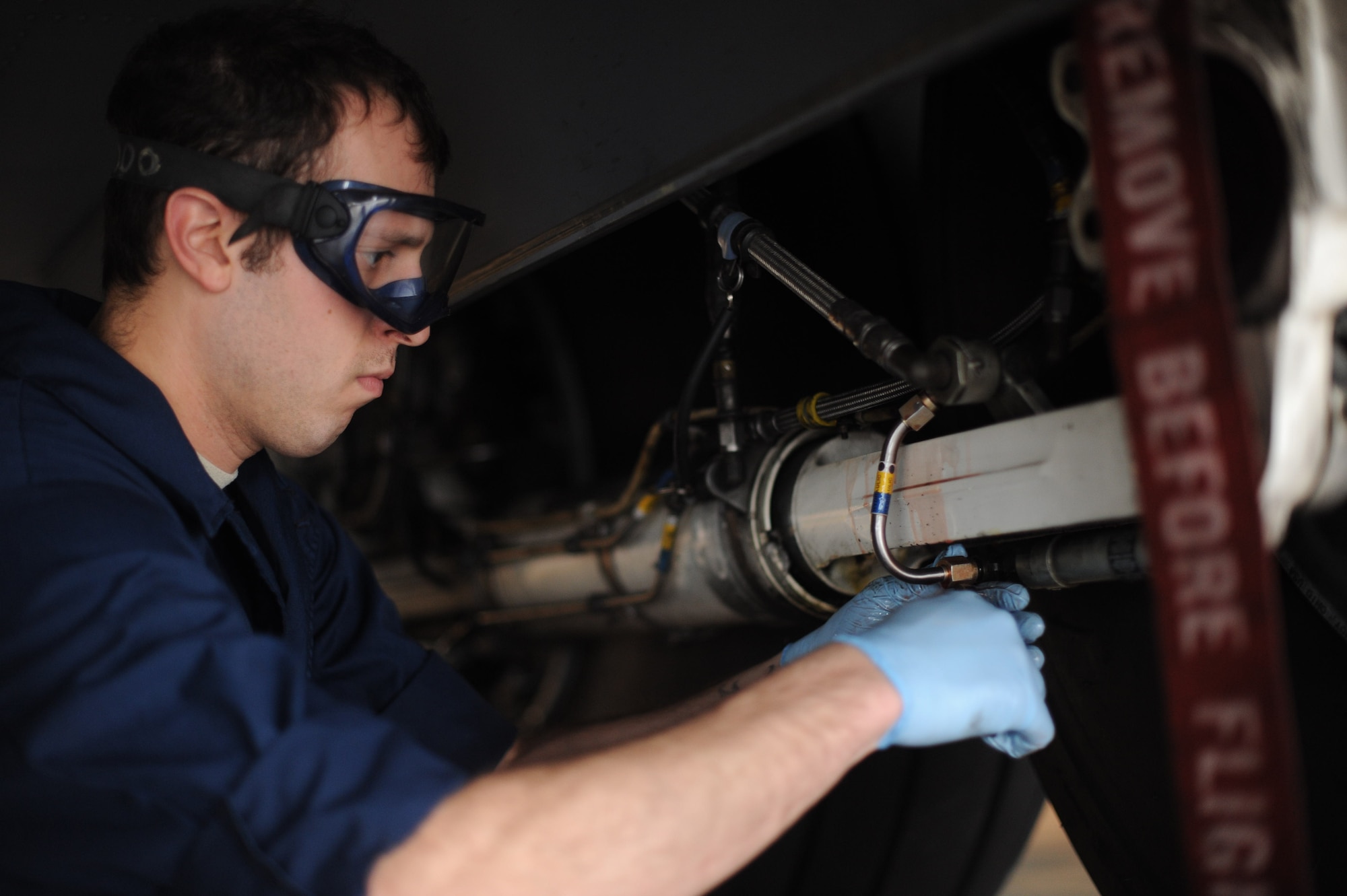 Senior Airman Vasilis Vasilakis , 86th Maintenance Squadron hydraulics systems journeyman, changes a C-130J Super Hercules emergency brake line on Ramstein Air Base, Oct. 21, 2014. The hydraulics team changes around 70 to 80 brakes a year. (U.S. Air Force photo/Airman 1st Class Michael Stuart) 