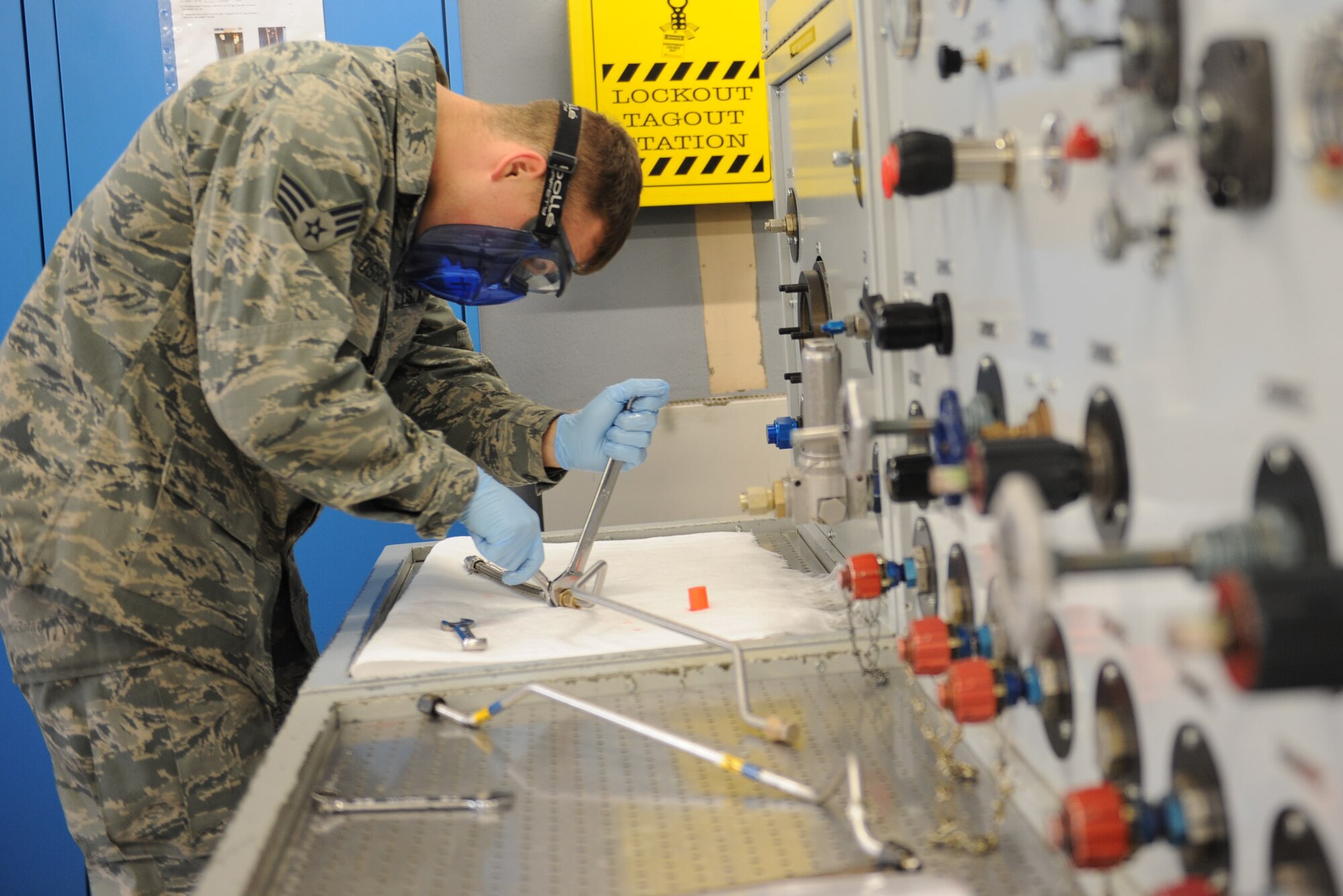 Senior Airman Jacob Osborne, 86th Maintenance Squadron hydraulics systems journeyman, tests a C-130J Super Hercules emergency brake line on Ramstein Air Base, Oct. 21, 2014. In case the main hydraulics system fails, the emergency line will automatically apply pressure to the brakes, slowing down the aircraft to safety. (U.S. Air Force photo/Airman 1st Class Michael Stuart) 