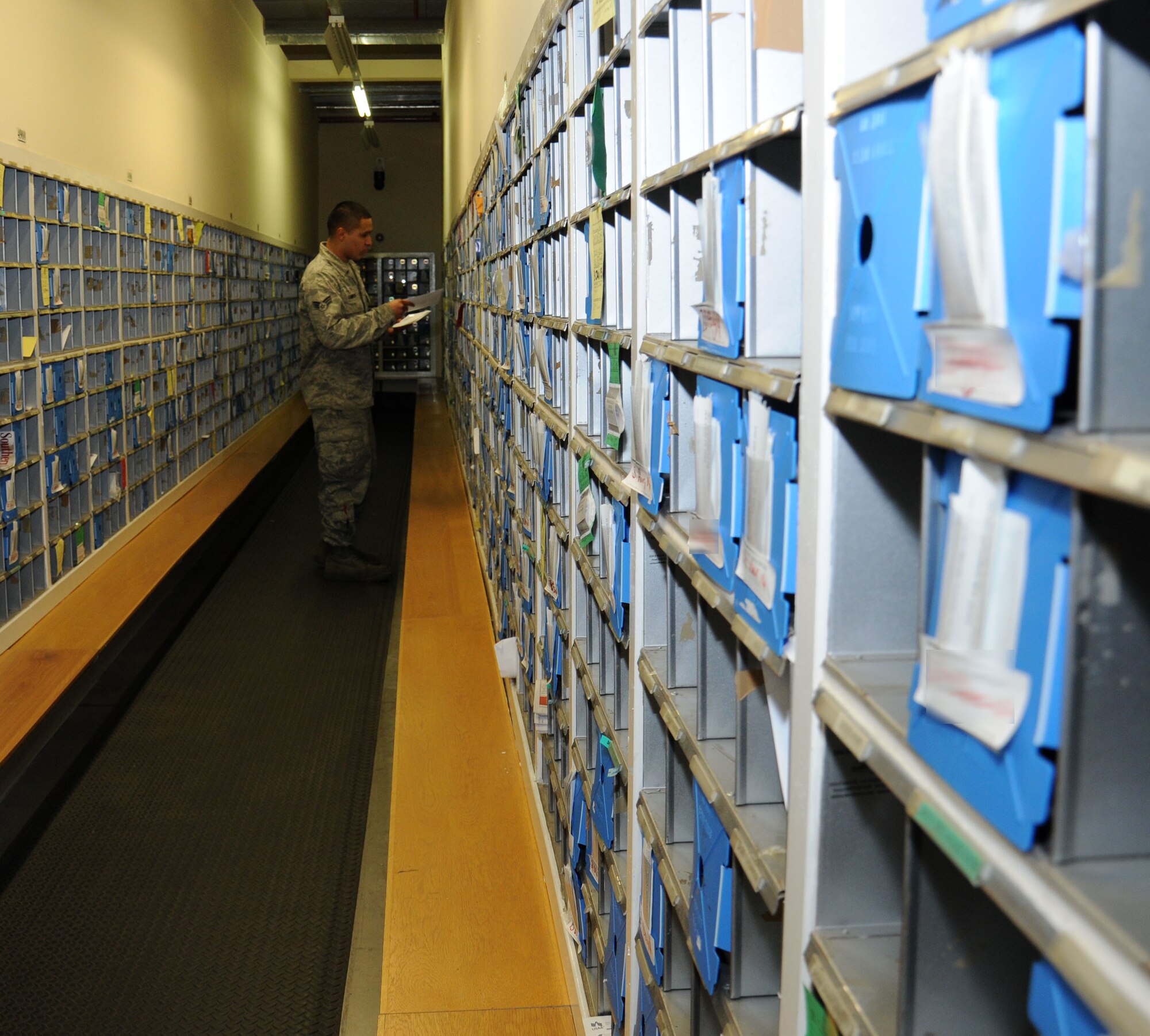 U.S. Air Force Senior Airman Oscar Campos-Ortiz, 100th Communications Squadron postal clerk from Dallas, sorts mail into customers’ mailboxes Oct. 24, 2014, on RAF Mildenhall, England. The RAF Mildenhall Post Office contains more than 6,000 mail receptacles. (U.S. Air Force photo by Gina Randall/Released)