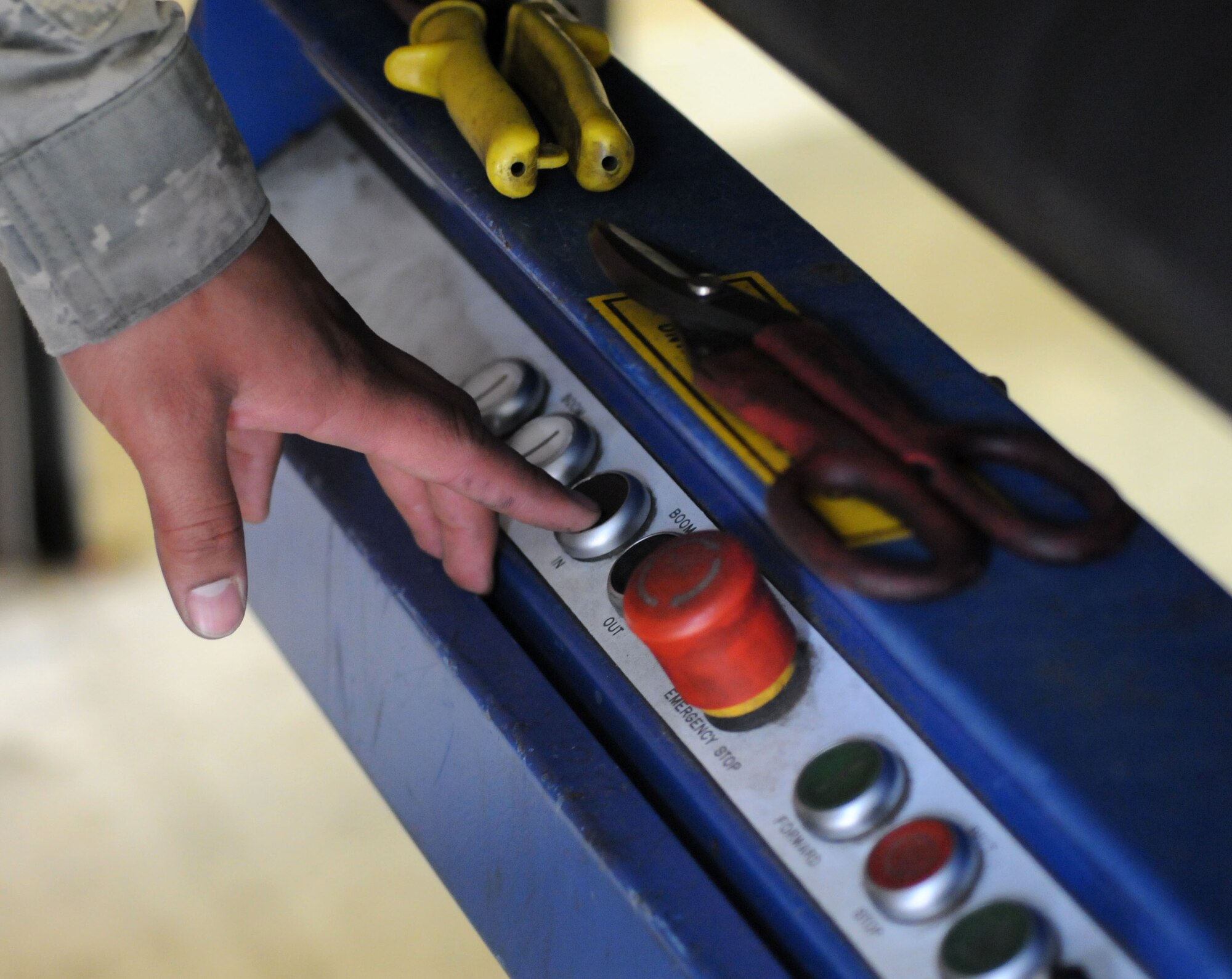 U.S. Air Force Senior Airman Oscar Campos-Ortiz, 100th Communications Squadron postal clerk from Dallas, moves a conveyor belt after using it to load packages onto the mail truck Oct. 24, 2014, on RAF Mildenhall, England. RAF Mildenhall receives a mail truck in the morning and dispatches one in the afternoon. (U.S. Air Force photo by Gina Randall/Released)