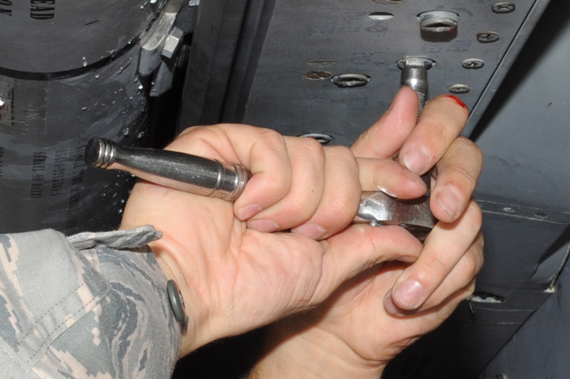 U.S. Air Force Staff Sgt. Jeffrey Burbank, 18th Maintence Squadron weapons load crew chief, works on the F-15C Eagle during the quarterly weapons loading competition at Kadena Air Base, Japan, Nov. 17, 2014. The competition tests the team's ability to load weapons on an F-15C Eagle in a fast and safe manner while increasing morale through healthy competition. (U.S. Air Force photo by Airman 1st Class Zackary A. Henry/Released)