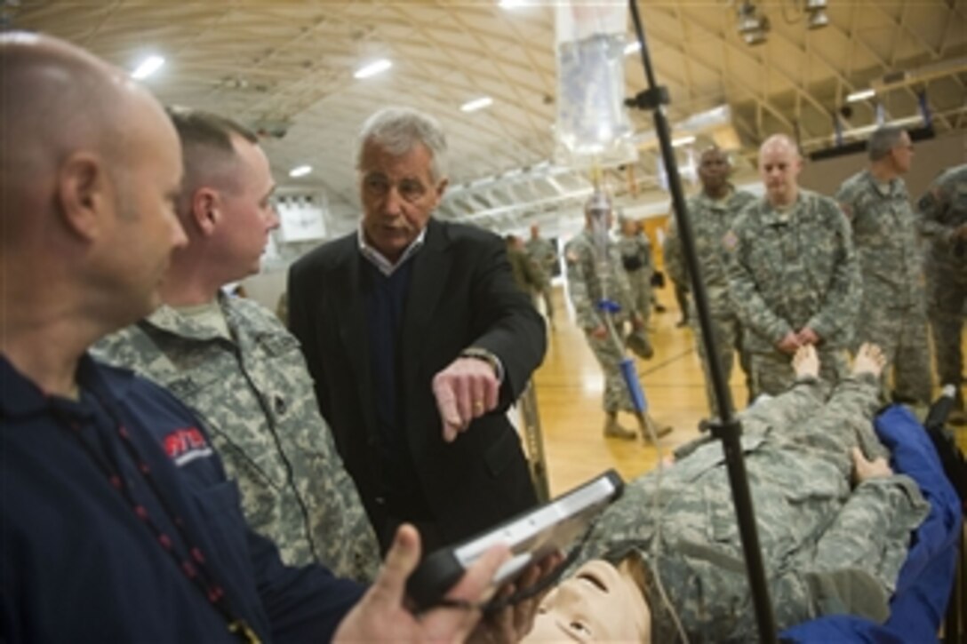 Defense Secretary Chuck Hagel observes simulated training for Operation United Assistance on Fort Campbell, Ky., Nov. 17, 2014. Hagel is visiting troops throughout the United States.