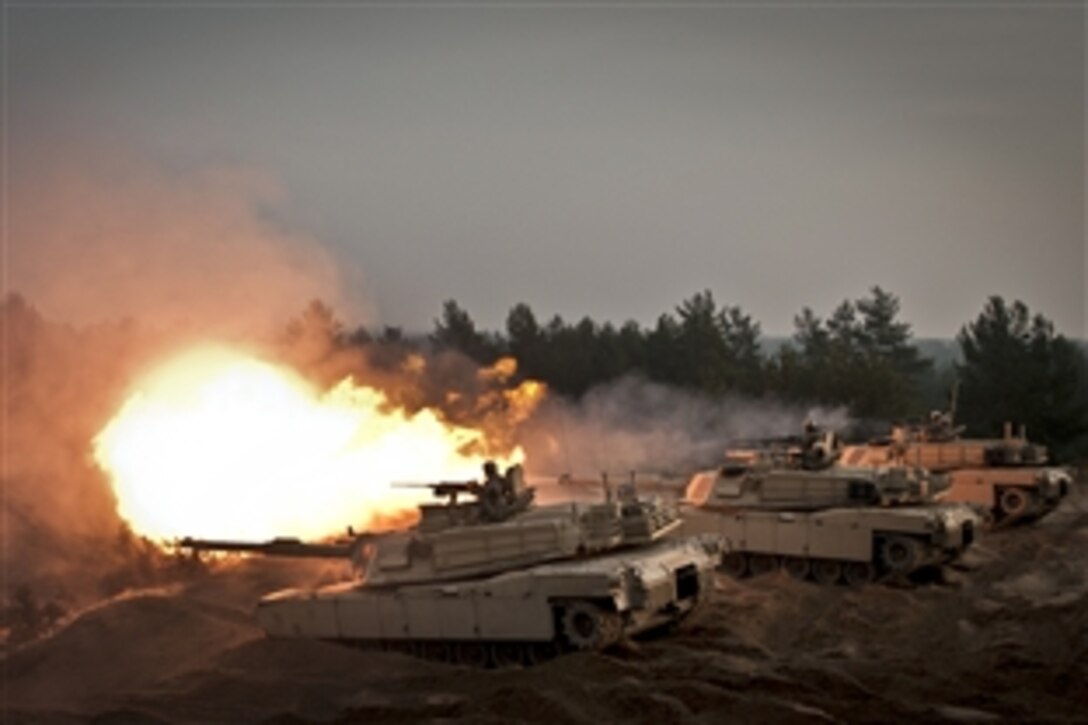 U.S. soldiers fire ceremonial rounds from M1A2 Abrams Tanks at the Adazi Training Area, Latvia, Nov. 6, 2014. The soldiers are helping to train the Latvian Land Forces as part of Operation Atlantic Resolve. The solders are assigned to 1st Cavalry Division, Charlie Company, 2nd Battalion, 8th Cavalry Regiment, 1st Brigade Combat Team.
