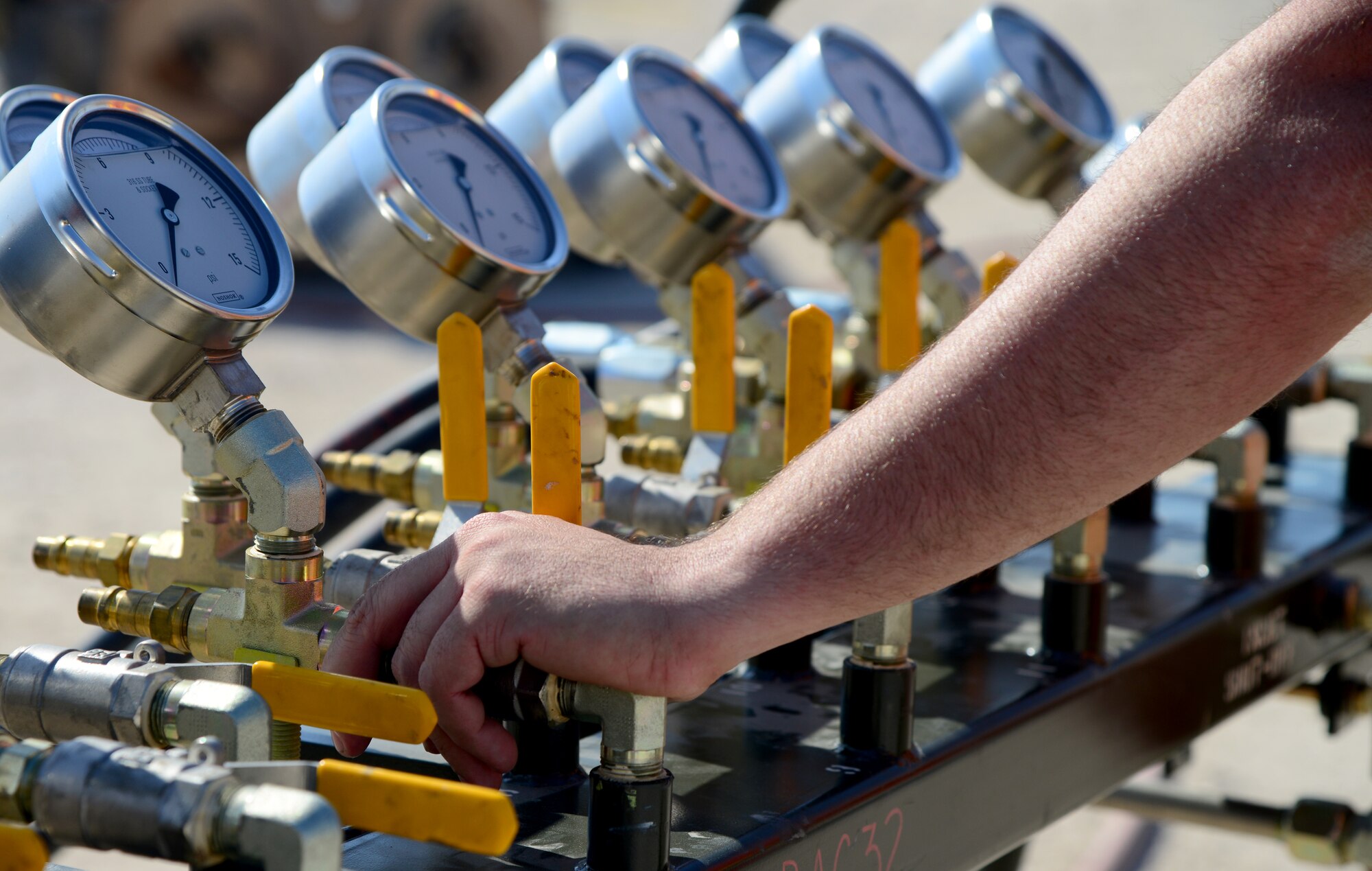 An Airman from the 379th Expeditionary Maintenance Group Crashed, Damaged, Disabled Aircraft Recovery (CDDAR) team controls the flow of air going into an air bag used to lift a simulated damaged aircraft during an exercise, Nov. 11, 2014, at Al Udeid Air Base, Qatar. The team, made up of maintainers from several airframes, deploys anywhere they're needed in the area of responsibility to assess aircraft damaged in accidents. To do this, they prepare for possible scenarios and always have their equipment ready to go. (U.S. Air Force photo by Senior Airman Kia Atkins)