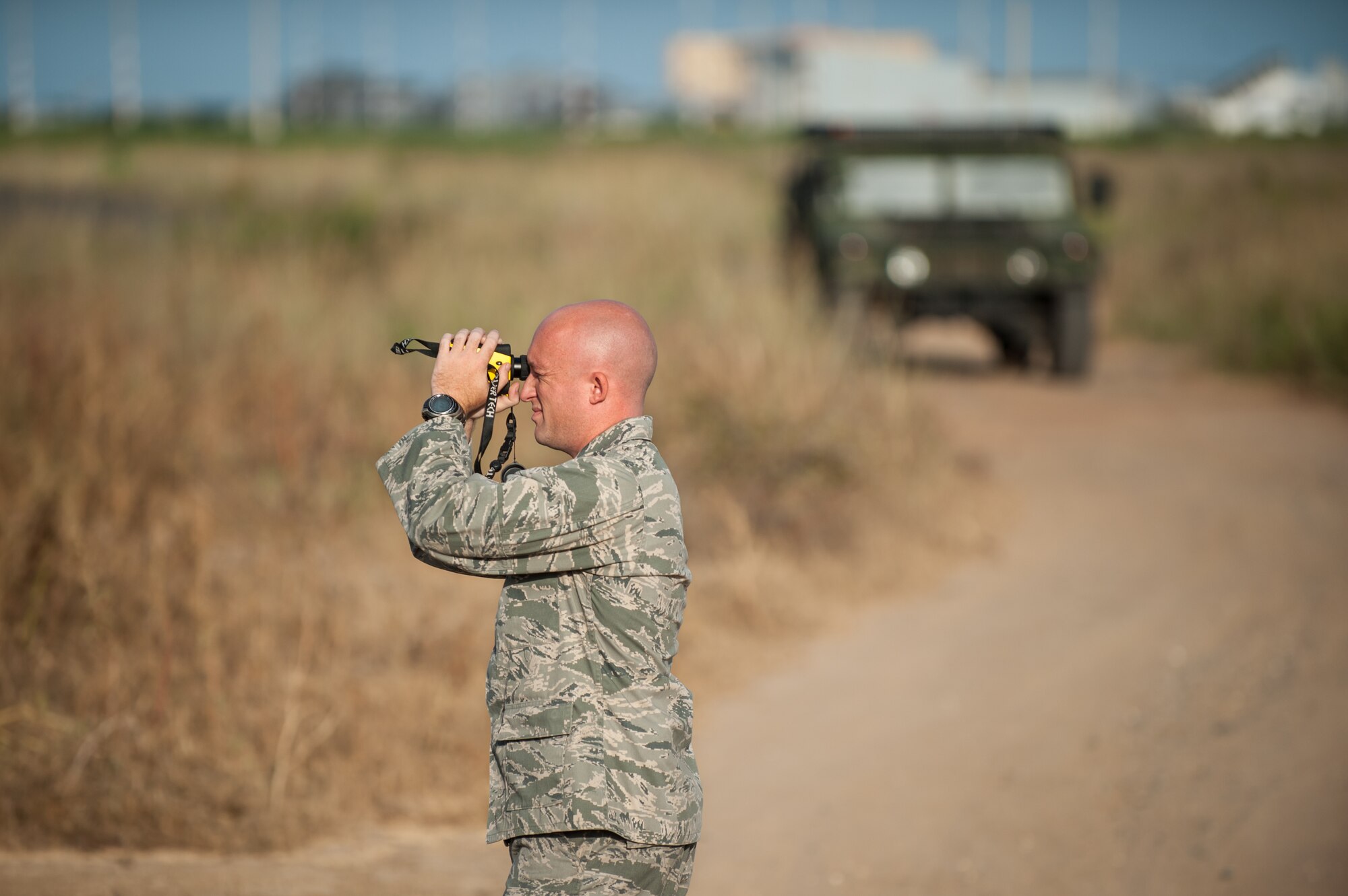 Capt. Jeffrey Higgs takes laser rangefinder measurements for a cargo yard Oct. 30, 2014, at the Léopold Sédar Senghor International Airport in Dakar, Senegal. More than 70 Kentucky Air Guardsmen are operating an Aerial Port of Debarkation in Senegal to funnel humanitarian supplies and military support into West Africa as part of Operation United Assistance, the U.S. Agency for International Development-led, whole-of-government effort to contain the Ebola virus outbreak. Higgs is an airfield operations officer for the Kentucky Air National Guard’s 123rd Contingency Response Group. (U.S. Air National Guard photo/Maj. Dale Greer)