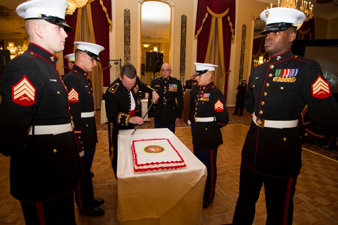 Maj. Charles D. Godwin cuts the Marine Corps birthday cake during Recruiting Station Milwaukee’s Birthday Ball ceremony in Milwaukee, Wis., Nov. 15, 2014.  The birthday cake is passed from the oldest to the youngest Marine present, symbolizing the passing of history and traditions to the next generation.  
