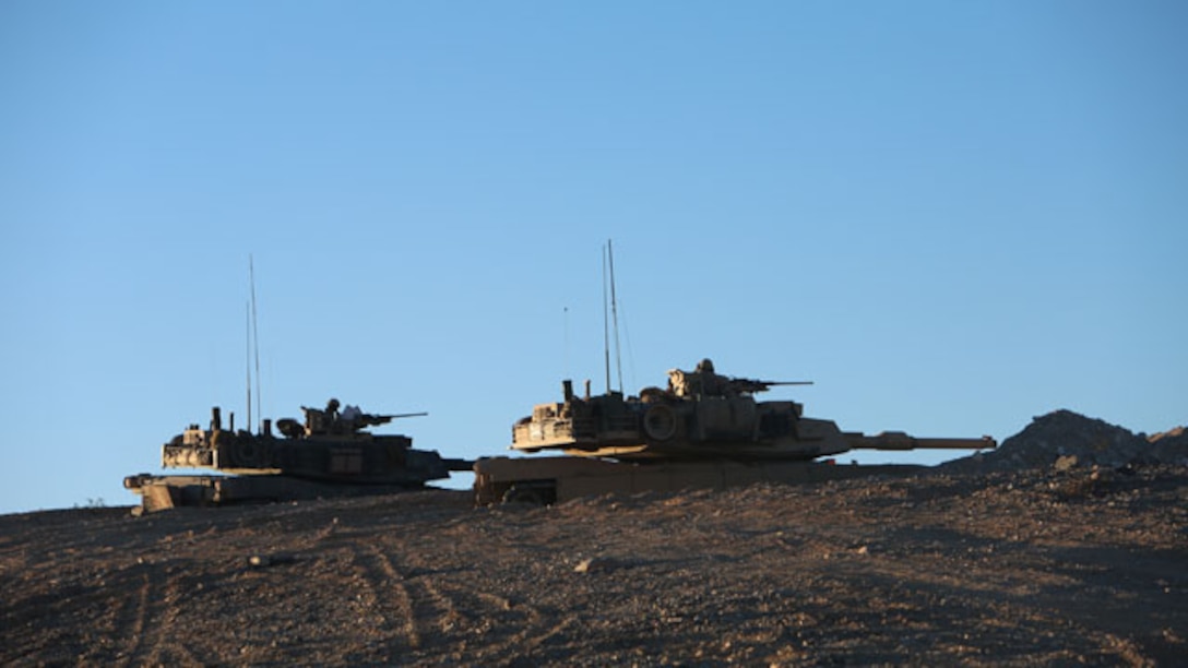 Captain Christopher Upton, the commanding officer for Company A, 1st Tank Battalion, 1st Marine Division, from Macon, Georgia, and 1st Lt. Martin Wetterauer, the executive officer for Company A, from Baton Rouge, Louisiana, overlook the objective area during the Tank Mechanized Assault Course aboard Marine Corps Air Ground Combat Center Twentynine Palms, Calif., Nov. 3, 2014. From this tactical position they were able to make adjustments and call the shots on the battlefield.
