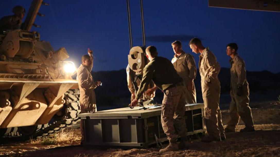 Marines with Company A, 1st Tank Battalion work together with 1st Combat Engineer Battalion Marines to prepare a mine-clearing line charge to be loaded in an assault breacher vehicle for the Tank Mechanized Assault Course during the Integrated Training Exercise aboard Marine Corps Air Ground Combat Center Twentynine Palms, Calif., Nov. 2, 2014. Company A Marines also worked with infantry, mortars, and air support during their assault.