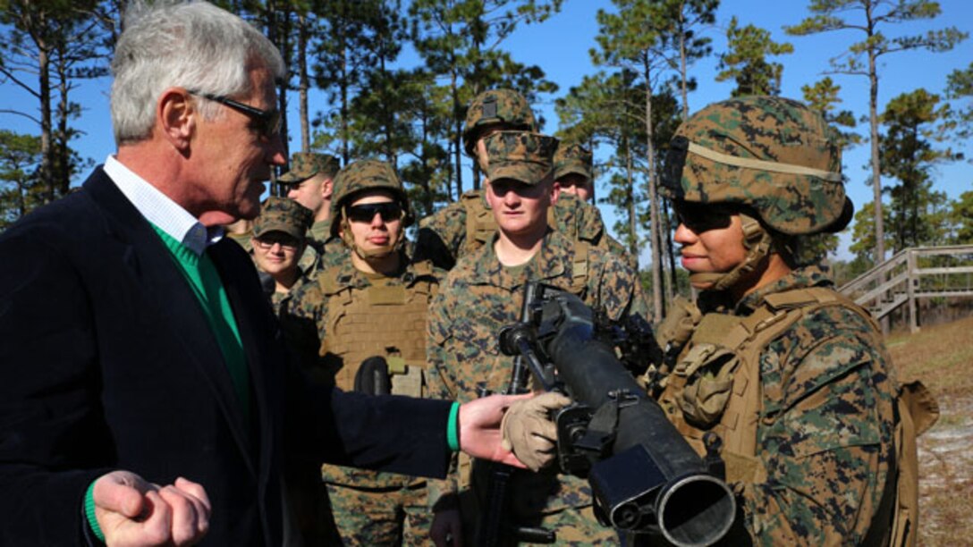 Secretary of Defense Chuck Hagel prepares to give his coin to Cpl. Janelle A. Lopez, assaultman with the Anti-Armor Section, Weapons Company, Ground Combat Element Integrated Task Force, after observing the Marines conduct a Mk-153 shoulder-launched multipurpose assault weapon live-fire during his visit to Marine Corps Base Camp Lejeune, North Carolina, Nov. 18, 2014. (U.S. Marine Corps photo by Sgt. Alicia R. Leaders/Released)