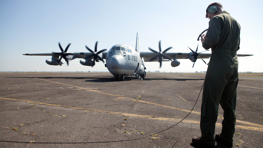 Lance Cpl. Kasey Pike, a native of Neptune Beach, Florida, talks to the pilots of a KC-130J from Marine Aerial Refueler Transport Squadron 152 via interphone communications system Nov. 8 as the aircraft prepares to take off from Clark Air Base. Marines and aircraft from VMGR-152, Marine Medium Tiltrotor Squadron 265 and VMM-262 flew approximately  4,700 miles from Okinawa, Japan to Brisbane, Australia to provide aerial support for President Barack Obama and Marine Helicopter Squadron One during the G20 Summit. Together, the MV-22 “Osprey” and KC-130J “Hercules” are capable of quickly providing assault support to any location in the MarForPac area of operations. Pike is a crewmaster with VMGR-152. 