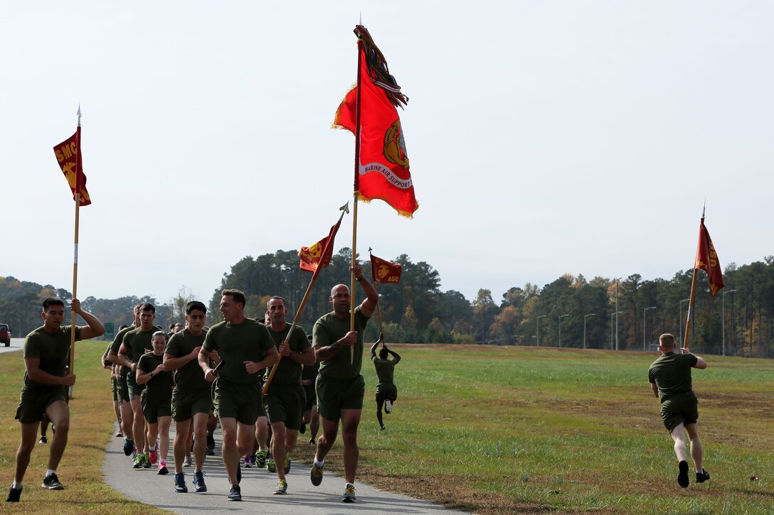 Marines with Marine Air Support Squadron 1 carry the squadron’s colors during the annual Chieftain Run at Marine Corps Air Station Cherry Point, N.C.,  Nov. 13, 2014. The squadron ran three-miles in formation then continued to run in three-man teams for 24-straight hours in honor of their fallen brethren and in celebration of the Marine Corps’ 239th birthday.