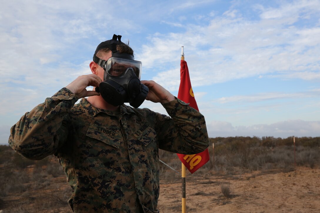 Cpl. Spencer Studer, training noncommissioned officer with Marine Wing Communications Squadron (MWCS) 38, dons and clears his mask during a six-mile hike through the east side of Marine Corps Air Station Miramar, Calif., Nov. 14. The hike was a part of the squadrons’ annual birthday tradition.