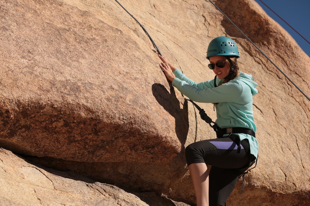 Pfc. Kristen Jenkins, student, Marine Corps Communication-Electronics School, ascends a rock face during a rock-climbing event for members of the Single Marine Program at Joshua Tree National Park, Calif., Nov. 9, 2014. Marines of the SMP were able to participate in this event due to the efforts of Joshua Tree Uprising and Mil-Tree, a non-profit organization. (Official Marine Corps photo by Pfc. Medina Ayala-Lo/Released)