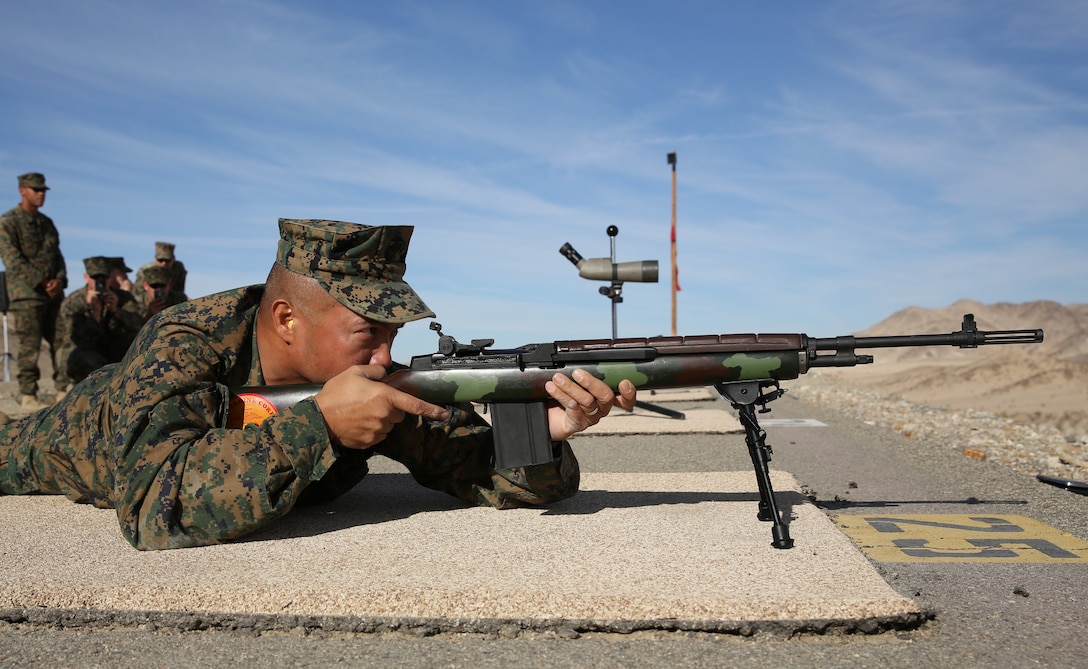 Sgt. Maj. Karl Villalino, Combat Center Sergeant Major, aims an M14 service rifle down range during the High Desert Regional Shooting Competition at the Combat Center, Nov. 13, 2014. Villalino fired the first shot, signifying the start of the competition. 