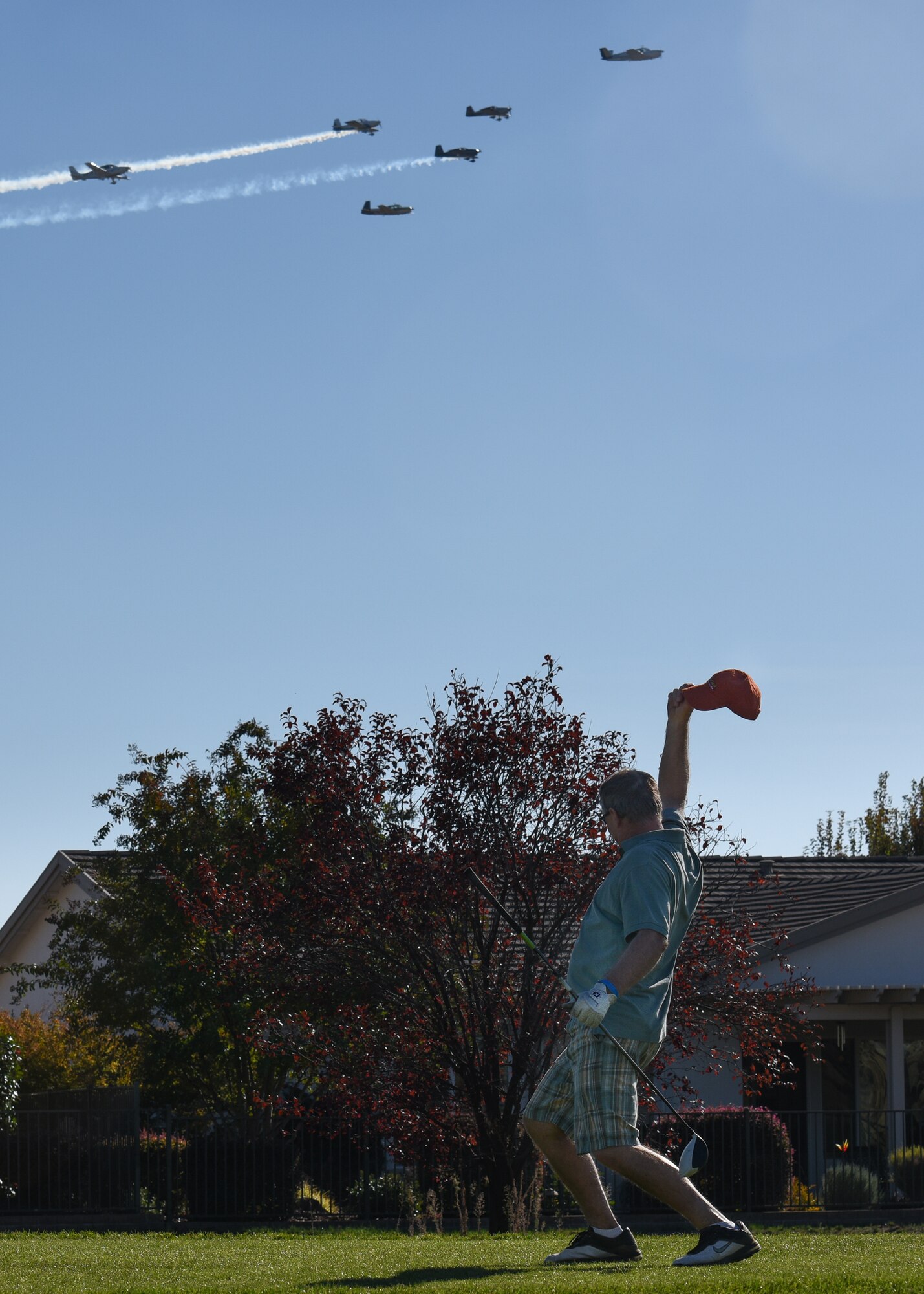 A golfer waves at The Beech Boys, aerial demonstration team, during the Patriots Honor golf tournament in Lincoln, Calif.,  Nov. 7, 2014.  The formation was led by 940th's own Lt. Col. John Tate. (U.S. Air Force photo by Staff Sgt. Brenda Davis/Released)
