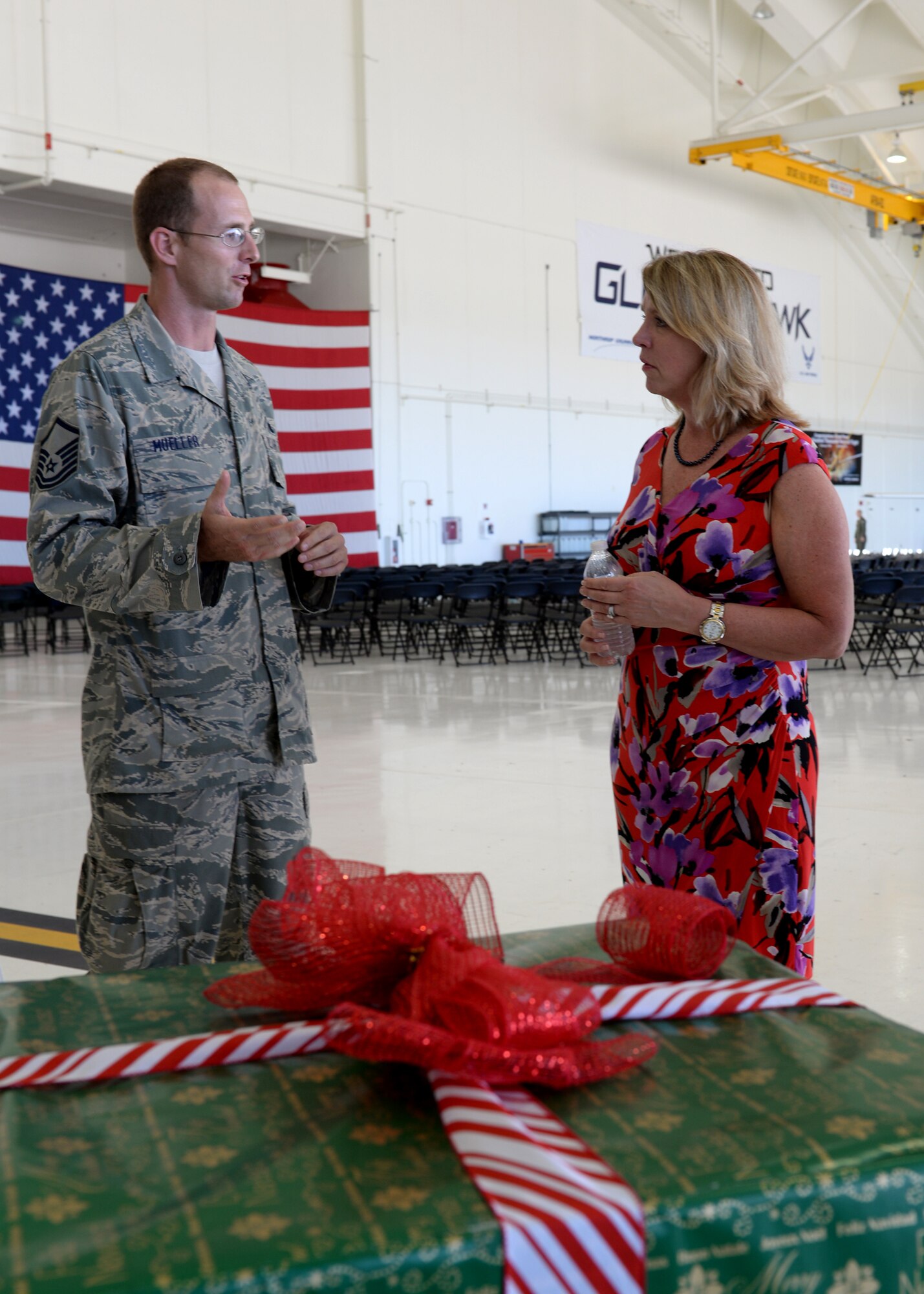 Master Sgt. Robert Mueller, 734th Air Mobility Squadron, discusses Operation Christmas Drop with the Secretary of the Air Force Deborah Lee James Nov. 19, 2014, on Andersen Air Force Base, Guam. Operation Christmas Drop is a joint venture between Andersen and Yokota Air Base, Japan, that uses mobility training missions to drop several tons of humanitarian supplies to dozens of remote Pacific islands every December and is the world's longest running airdrop operation in the world at 62 years running. James saw first-hand how Andersen Airmen contribute to the ongoing rebalance to the Pacific as well as their role to ensuring peace and security in the region. (U.S. Air Force photo by Airman 1st Class Amanda Morris/Released)