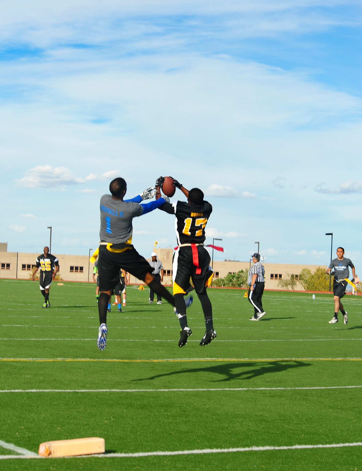 A member of the Fort Huachuca Black Knights intercepts a pass intended for a Davis-Monthan Air Force Base Desert Lightning Team wide receiver during the annual Turkey Bowl at Fort Huachuca, Ariz., Nov. 14, 2014. Fort Huachuca Black Knights lead the game until the D-M Airmen scored twice in the last 30 seconds. The final score was 18-7. (U.S. Air Force photo by Staff Sgt. Angela Ruiz/Released)