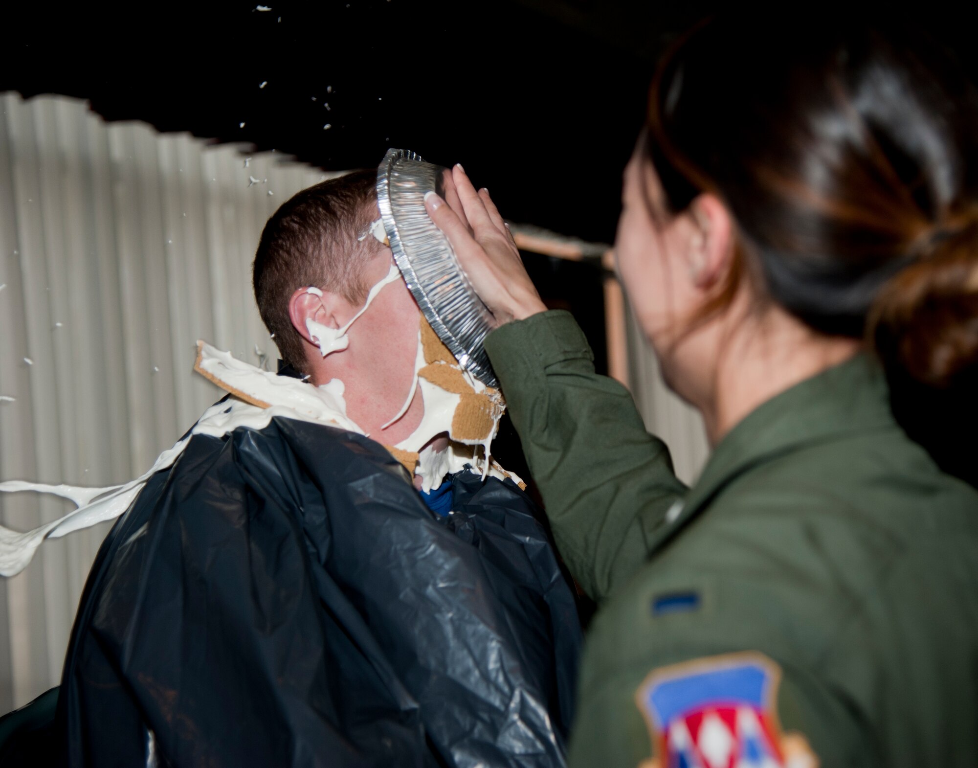 VANCE AIR FORCE BASE, Okla. -- 1st Lt. Patricia MaCartney, a 71st Medical Operations Squadron aerospace and operational physiologist, pies Capt. Mark Favinger, a 33rd Flying Training Squadron check flight instructional pilot, at the Vance Collocated Club during the pie-in-the-face fundraiser for the Combined Federal Campaign Nov. 14. The fundraiser raised $457. (U.S. Air Force photo/Staff Sgt. Nancy Falcon)