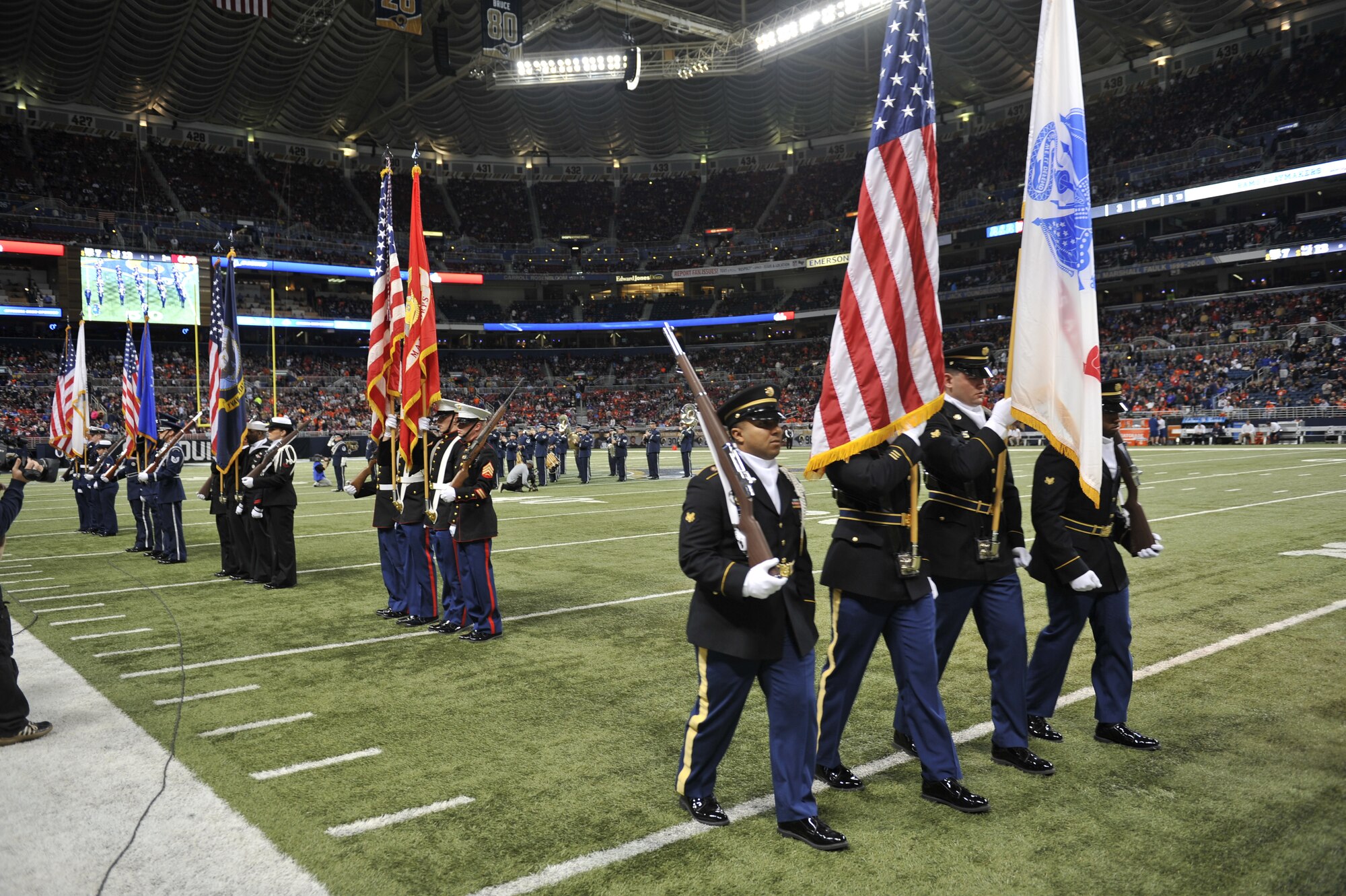 Honor guards representing every branch of the Armed Forces Pass-in-Review at Military Appreciation Day's halftime ceremony in the Edward Jones Dome, St. Louis, Nov. 16, 2014. The St. Louis Rams went up against the Denver Broncos, with the Rams winning 7-22. The day included honoring wounded warriors, and featured honor guards from every branch of the Armed Forces presenting the colors. (U.S. Air Force photo by Airman 1st Class Erica Crossen)
