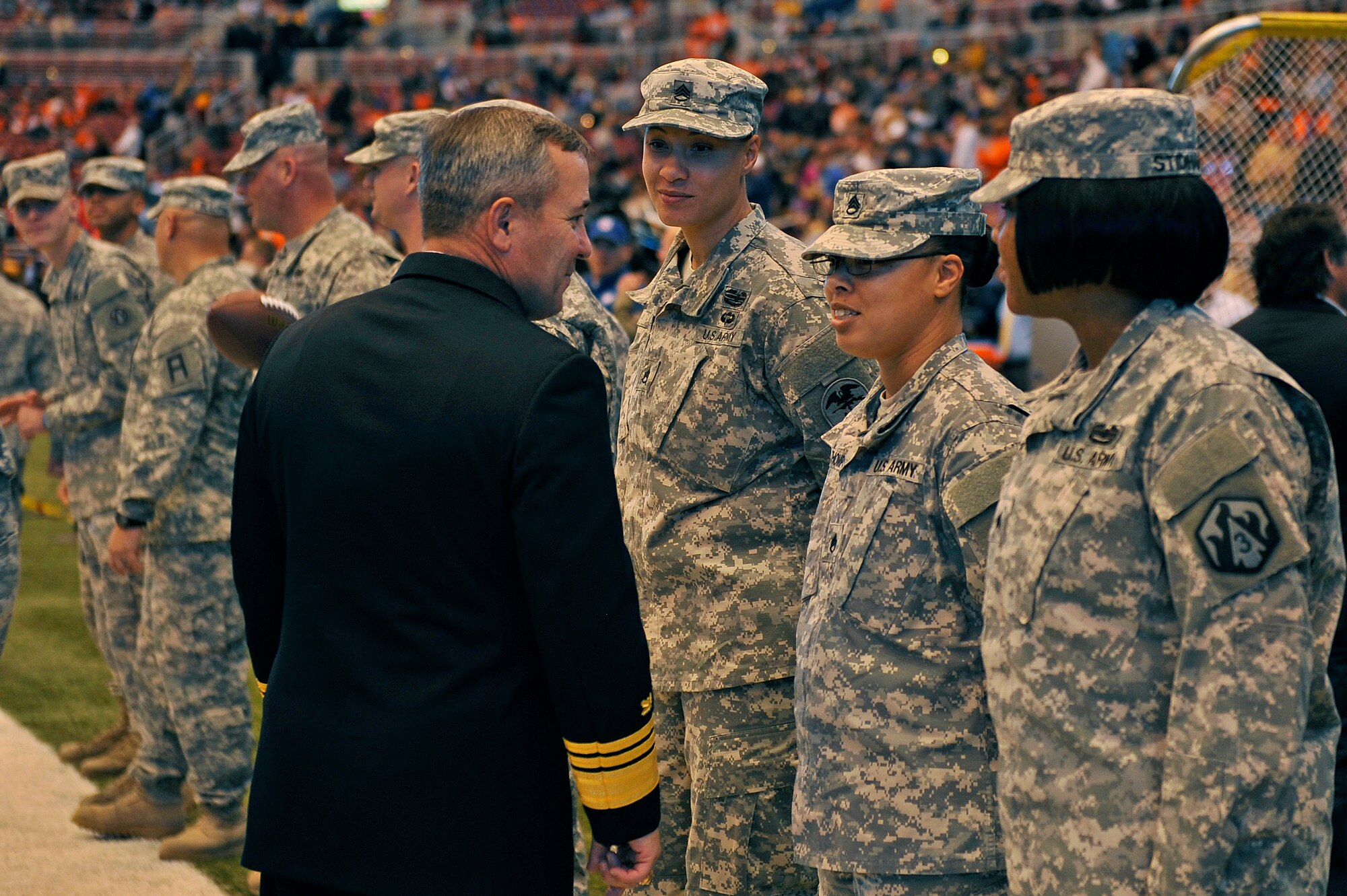 U.S. Navy Vice Adm. Andy Brown, the military guest of honor for Military Appreciation Day at the Rams versus Broncos football game, talks to Army servicemembers before the pregame ceremony starts, Edward Jones Dome, St. Louis, Nov. 16, 2014. The day included honoring wounded warriors and honor guards from every branch of the Armed Forces presented the colors. (U.S. Air Force photo by Airman 1st Class Erica Crossen)