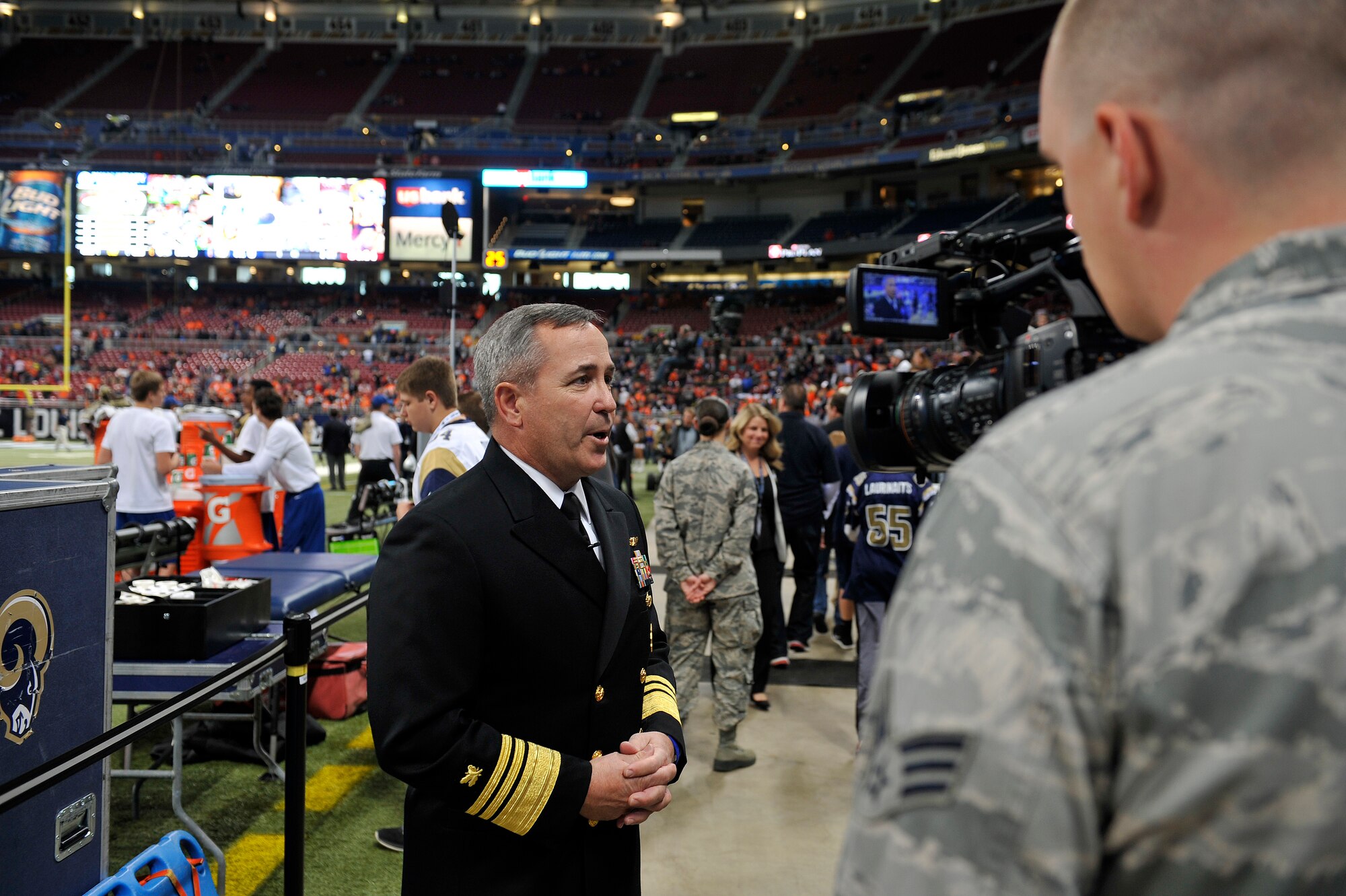 U.S. Navy Vice Adm. Andy Brown, the military guest of honor for Military Appreciation Day at the Rams versus Broncos football game, is interviewed by Senior Airman Timothy Kirchner, 375th Air Mobility Wing Broadcaster, about the event, Edward Jones Dome, St. Louis, Nov. 16, 2014. The day included honoring wounded warriors and honor guards from every branch of the Armed Forces presented the colors. The Rams won 7-22. (U.S. Air Force photo by Airman 1st Class Erica Crossen)