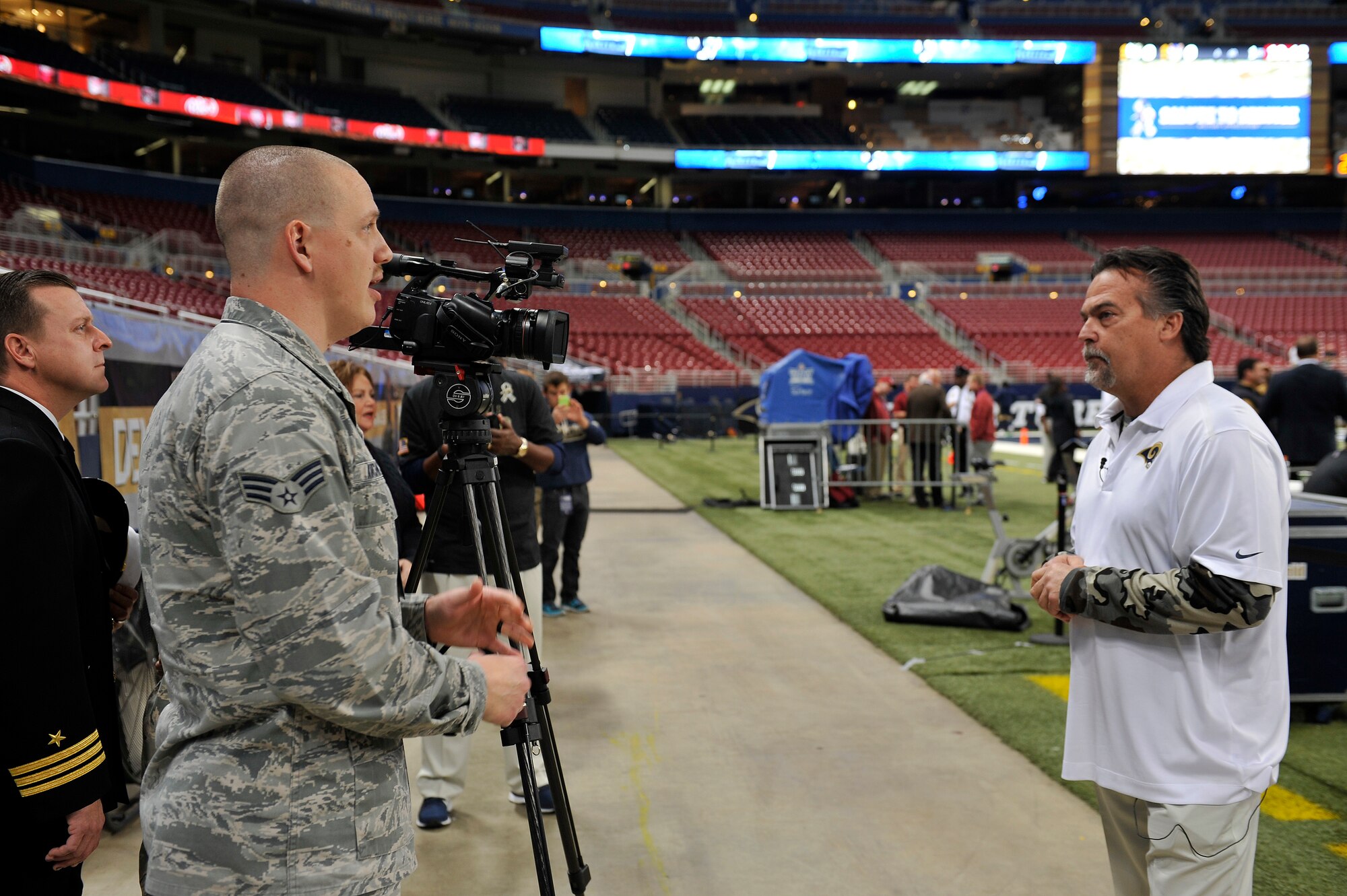 Jeff Fisher, the Head Coach for the St. Louis Rams, is interviewed by Senior Airman Timothy Kirchner, 375th Air Mobility Wing Broadcaster, about the Military Appreciation Day event during the Rams versus Broncos game, Edward Jones Dome, St. Louis, Nov. 16, 2014. The day included honoring wounded warriors and featured honor guards from every branch of the Armed Forces. (U.S. Air Force photo by Airman 1st Class Erica Crossen)