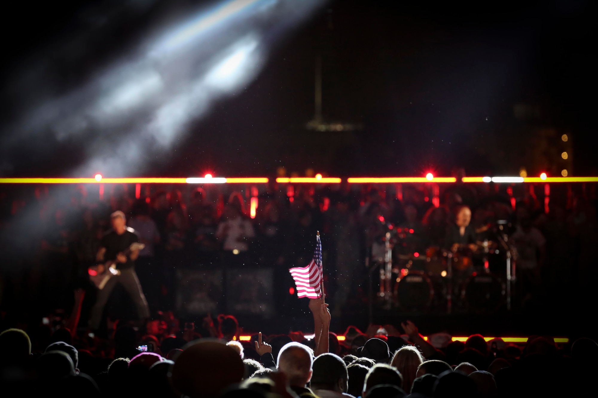 A miniature American flag catches the spotlight during Metallica's performance at "The Concert for Valor" on The National Mall, Tuesday, Nov. 11, 2014. (U.S. Air National Guard photo by 1st Lt. Nathan Wallin)