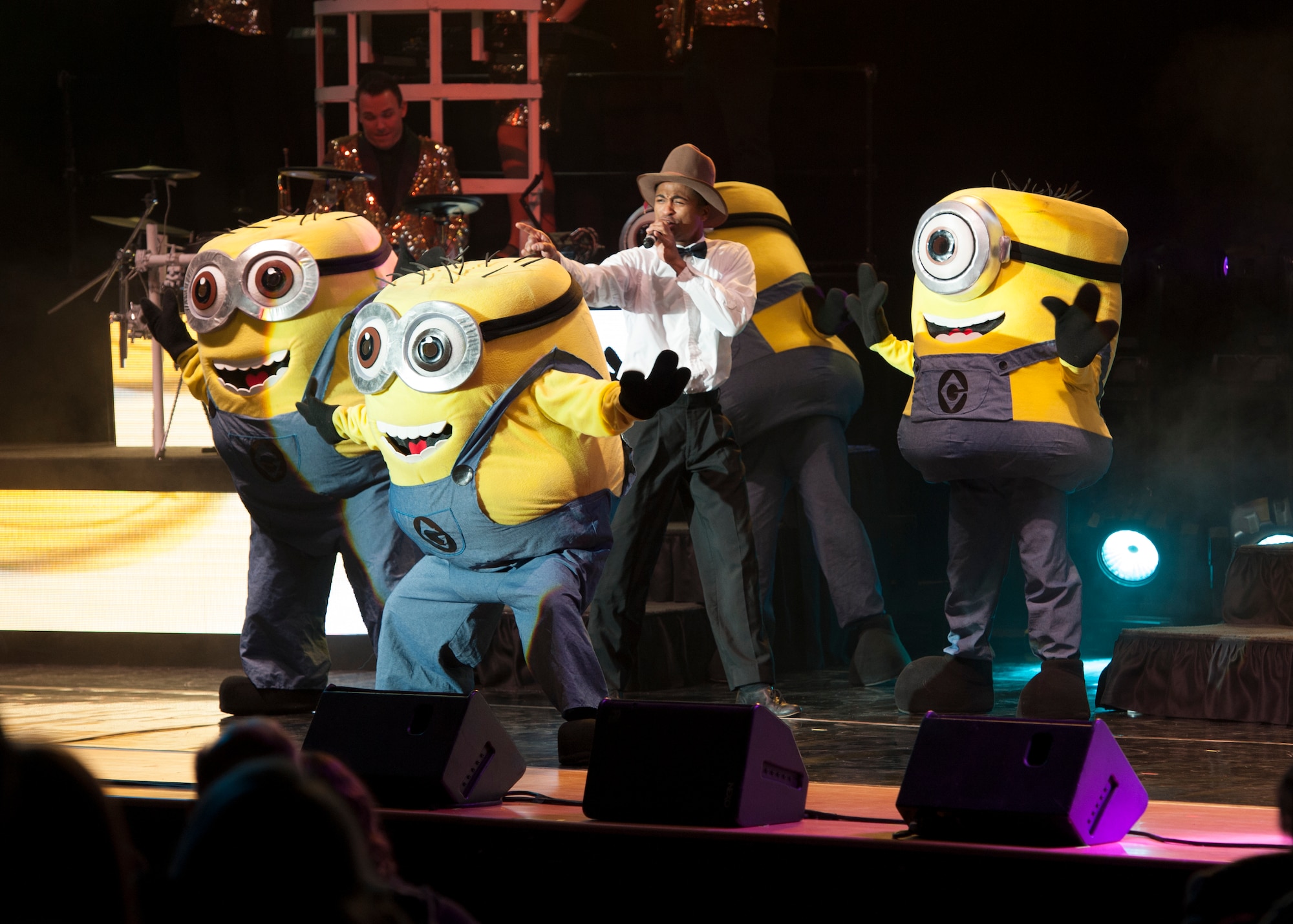Senior Airman Charles Cooper, 509th Logistics Readiness Squadron vehicle operations, sings with minions during a Tops in Blue show Nov. 18, 2014, at the Delaware State University in Dover, Del. Cooper performed the song “Happy” from performing artist, Pharrell Williams. (U.S. Air Force photo/Airman 1st Class Zachary Cacicia)