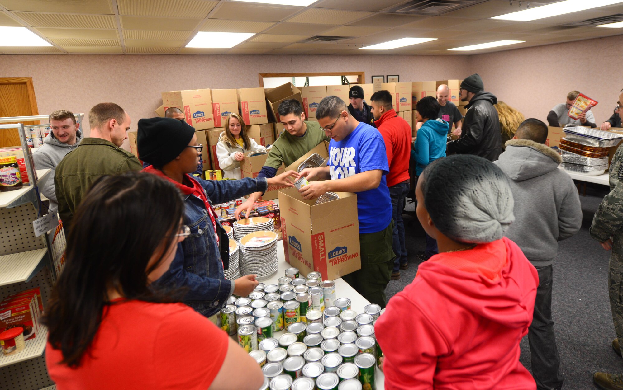 Airman Leadership School Class 15-2 students assist base first sergeants in assembling Thanksgiving meal baskets in the Diamond Mart as part of Operation Warmheart at Ellsworth Air Force Base, S.D., Nov. 16, 2014. Each basket destined to Ellsworth families who qualify, contained ingredients to make traditional Thanksgiving dishes including mashed potatoes, pumpkin pie, green bean casserole and turkey or ham. (U.S. Air Force photo by Senior Airman Zachary Hada/Released)