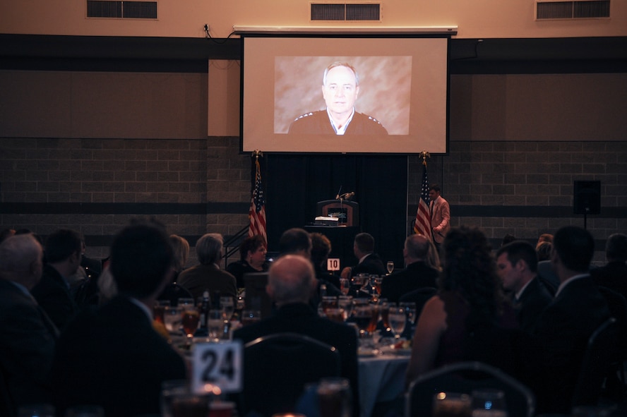 Guests of the 2014 Flying Tiger Reunion dinner watch a recorded video message from Air Force Chief of Staff Gen. Mark A. Welsh III at the 2014 Flying Tigers Reunion dinner Nov. 15, 2014, at the James H. Rainwater Conference Center in Valdosta, Ga. In the video, Welsh personally thanked the three original Flying Tigers in attendance for paving the way for generations that followed their legacy. (U.S. Air Force photo by Andrea Jenkins/Released)