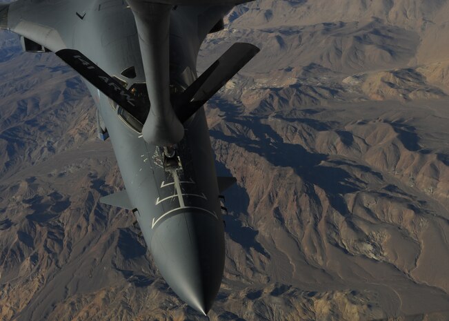 A B-1B Lancer assigned to the 34th Bomb Squadron, Ellsworth Air Force Base, S.D., maneuvers into position over the Southern California desert to be refueled by a KC-135 Stratotanker assigned to the 93rd Air Refueling Squadron, Fairchild AFB, Wash., Nov. 18, 2014. Both aircraft were temporarily assigned to Nellis AFB to participate in Green Flag-West 15-02. (U.S. Air Force photo by Airman 1st Class Joshua Kleinholz)