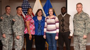 U.S. Army Col. William Galbraith, 733rd Mission Support Group commander, second from left, and U.S. Air Force Col. John J. Allen, Jr., 633rd Air Base Wing commander, far right, recognize the Fort Eustis Volunteers of the Third Quarter during a ceremony at Fort Eustis, Va., Nov. 18, 2014. The group of volunteers was lauded for making a significant impact in their units. (U.S. Air Force photo by Staff Sgt. Teresa J. Cleveland/Released)