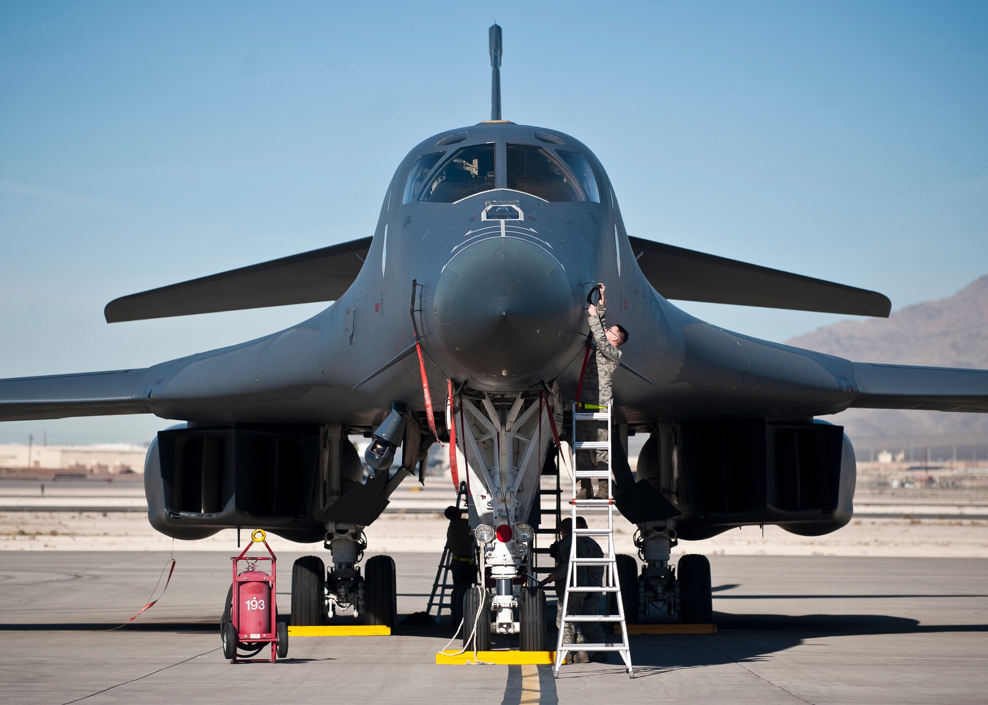 Crew chiefs from the 34th Aircraft Maintenance Unit, Ellsworth Air Force Base, S.D., perform a pre-flight inspection on a B-1B Lancer assigned to the 34th Bomb Squadron, Ellsworth AFB, during Green Flag-West 15-02 at Nellis AFB, Nev., Nov. 18, 2014. Typical Green Flag exercises involve multi-role fighters and/or bomber squadrons, unmanned aircraft, electronic warfare aircraft, and aerial refueling aircraft at the U.S. Army National Training Center, Fort Irwin, Calif. (U.S. Air Force photo by Staff Sgt. Siuta B. Ika)