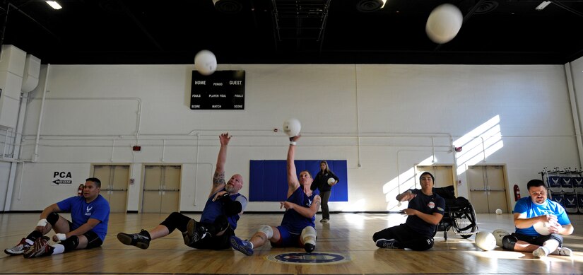 Air Force wounded, ill or injured warriors practice serving at the Joint Base Andrews West Fitness Center, Nov. 18, for an upcoming Pentagon Sitting Volleyball Tournament. The one-day tournament is designed to bring awareness to the challenges of the wounded, ill or injured population. (U.S. Air Force photo/Tech. Sgt. Brian Ferguson)