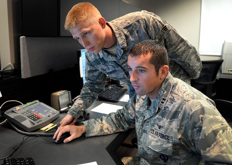 Capt. Jared Delaney, right, and Senior Airman Bryan Wynkoop, 19th Space Operations Squadron satellite system operators, monitor telemetry during the GPS SVN-69 launch Oct. 29, 2014 at Schriever Air Force Base, Colo.  (U.S. Air Force photo/Dennis Rogers)