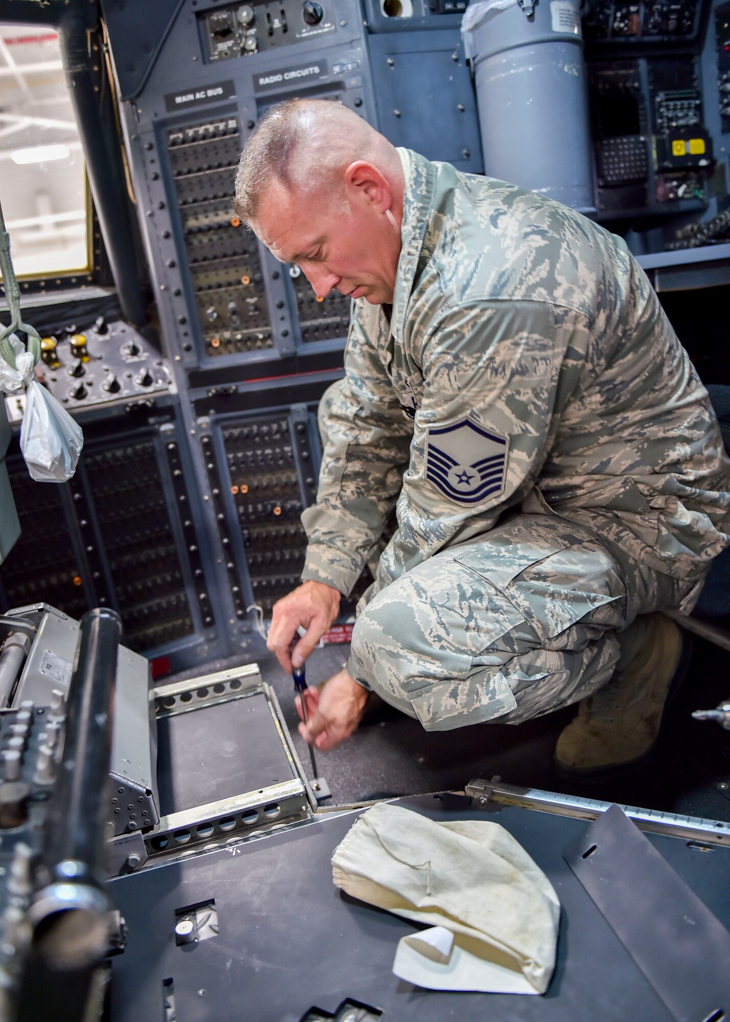 Master Sgt. Ed Shaffer, an aircraft maintenance craftsman with the 910th Maintenance Squadron, loosens an armor plating fastener in the flight deck of a C130 Hercules aircraft here, Nov. 6, 2014. Youngstown is the second base to receive a test version of the new system, designed for easier and more secure installation and better protection for aircrew members. (U.S. Air Force photo/Eric M. White)
