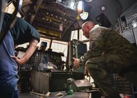Master Sgt. Ed Shaffer, an aircraft maintenance craftsman with the 910th Aircraft Maintenance Squadron, examines a new armor plating system with a contractor in the flight deck of a C-130 Hercules aircraft here, Nov. 6, 2014. Youngstown is the second base to receive a test version of the new system, designed for easier and more secure installation and better protection for aircrew members. (U.S. Air Force photo/Eric M. White)